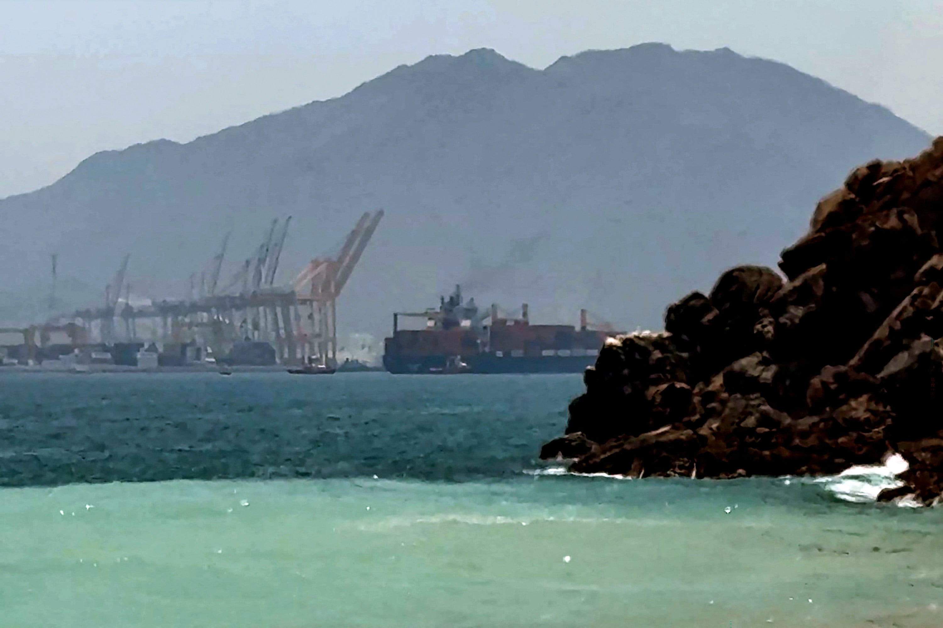 A ship sails near the Strait of Hormuz off the eastern coast of the United Arab Emirates at Khor Fakkan on Sunday. Photo: AFPTV