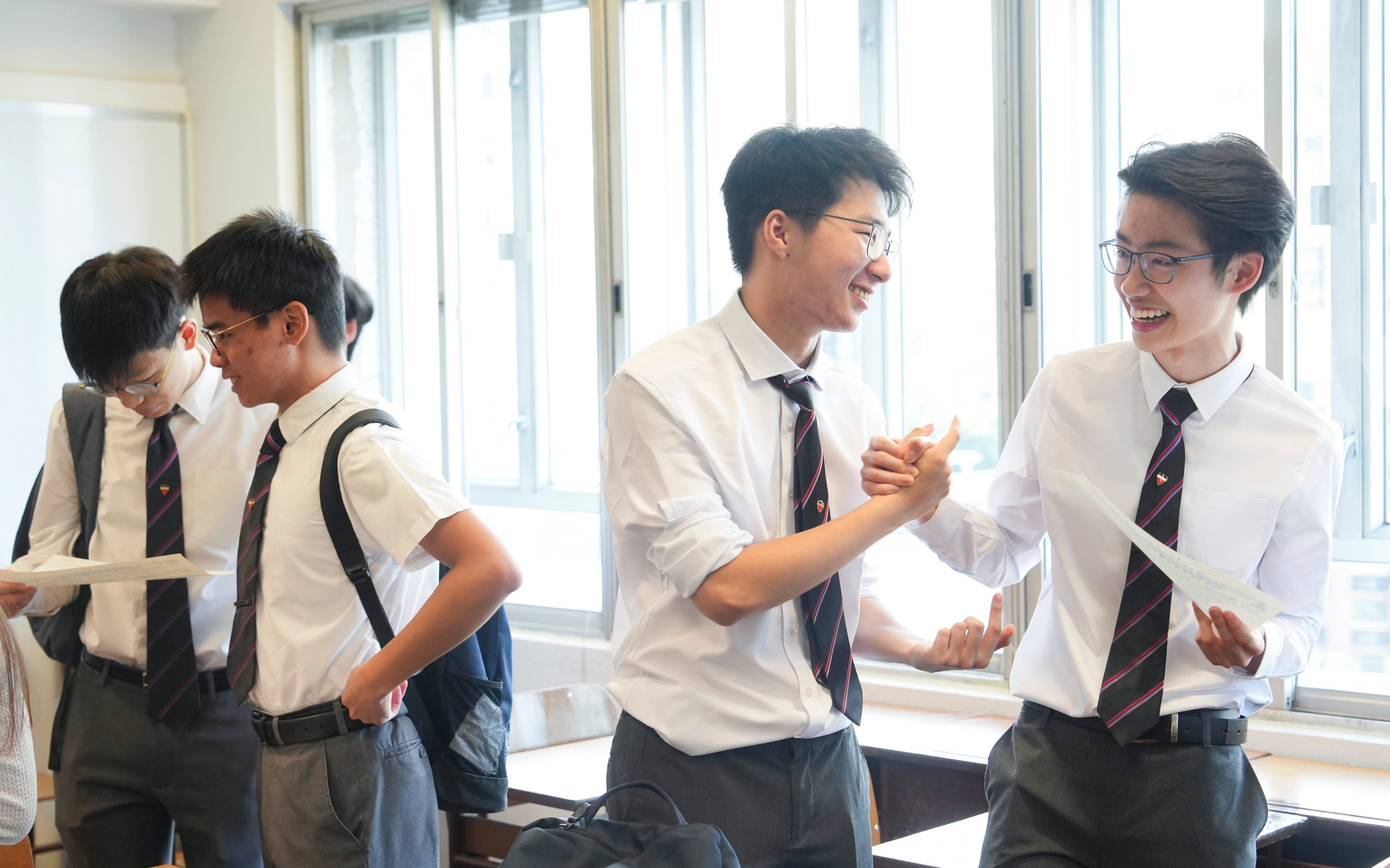 Students at La Salle College in Kowloon Tong react to their Hong Kong Diploma of Secondary Education Examination (DSE) results on Wednesday, July 16, 2025 morning. Photo: Sun Yeung