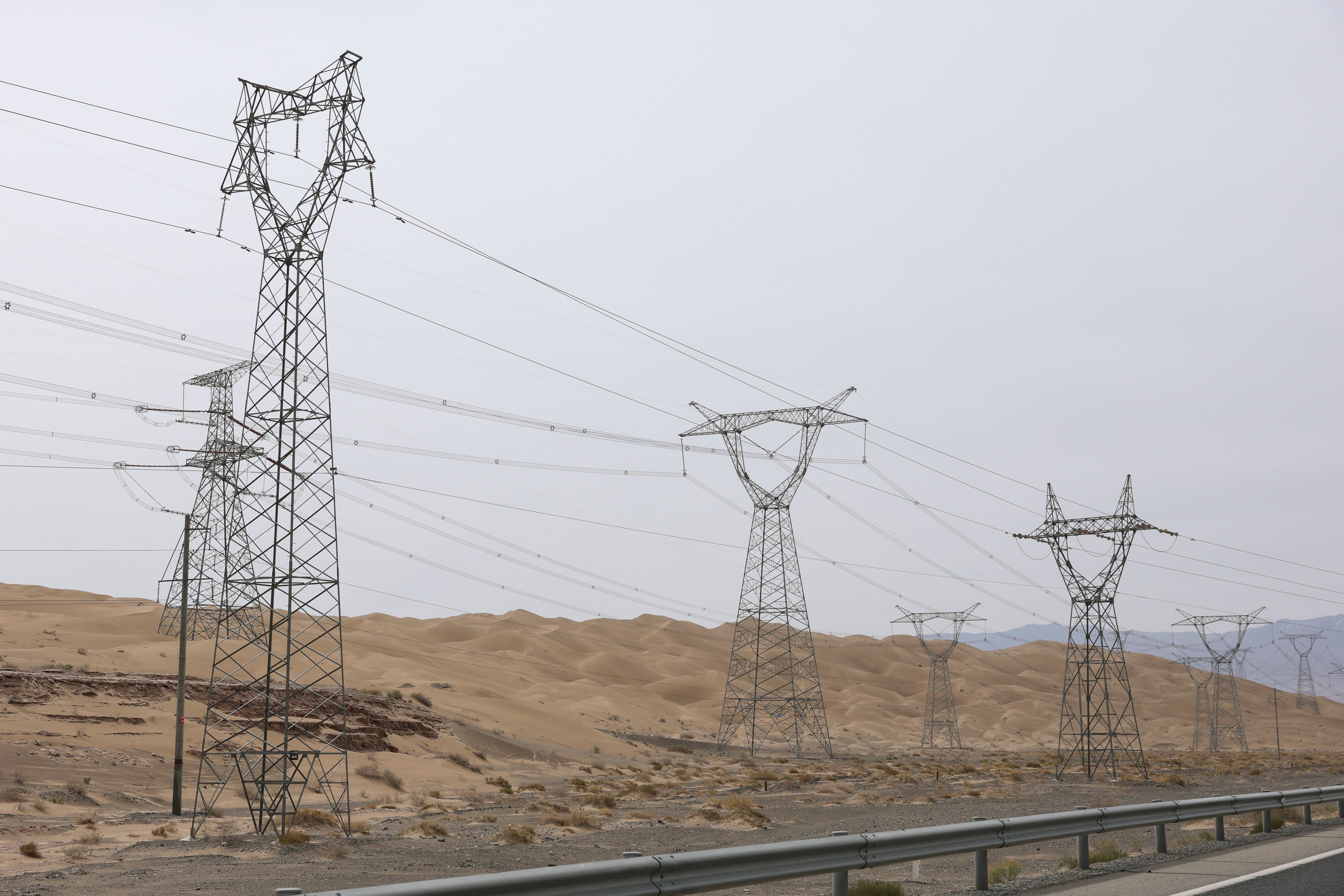 High-voltage transmission towers and power lines in Dunhuang, China on June 1. Photo: Zhe Ji