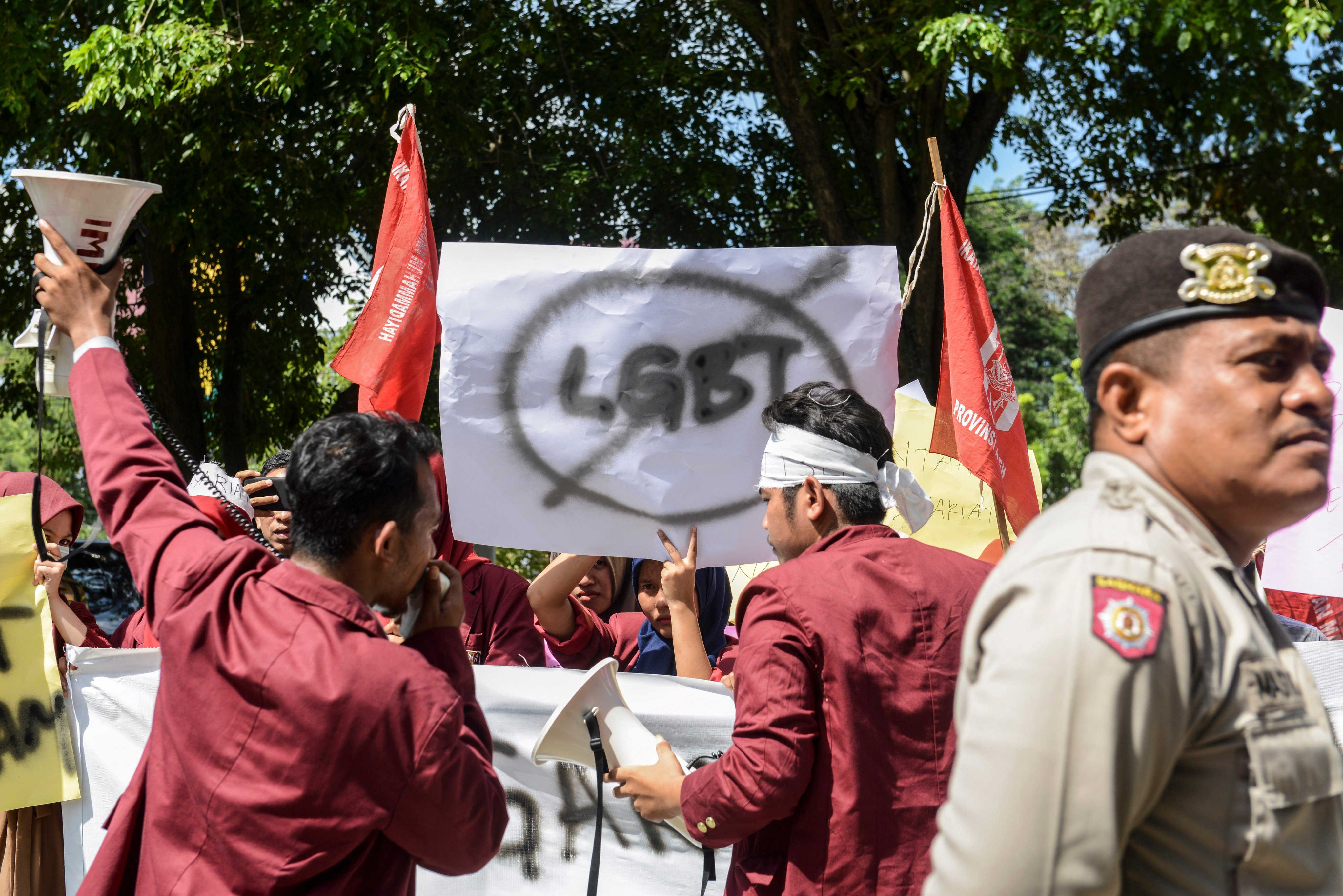 Protesters march with banners against the LGBT community in Banda Aceh in December 2017. Photo: AFP