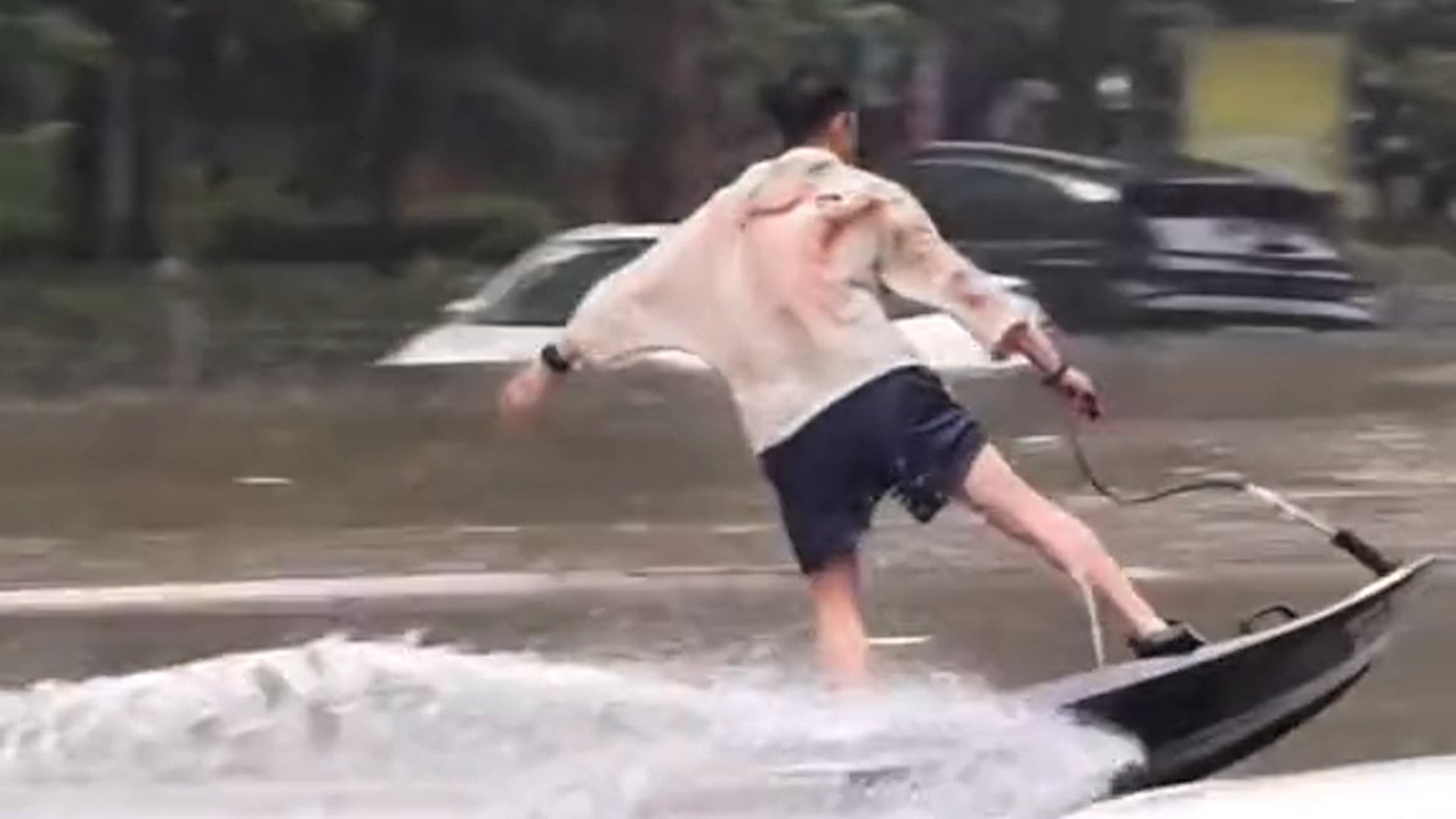 People kayak on street floods after Typhoon Bavi brings record rains to northern China