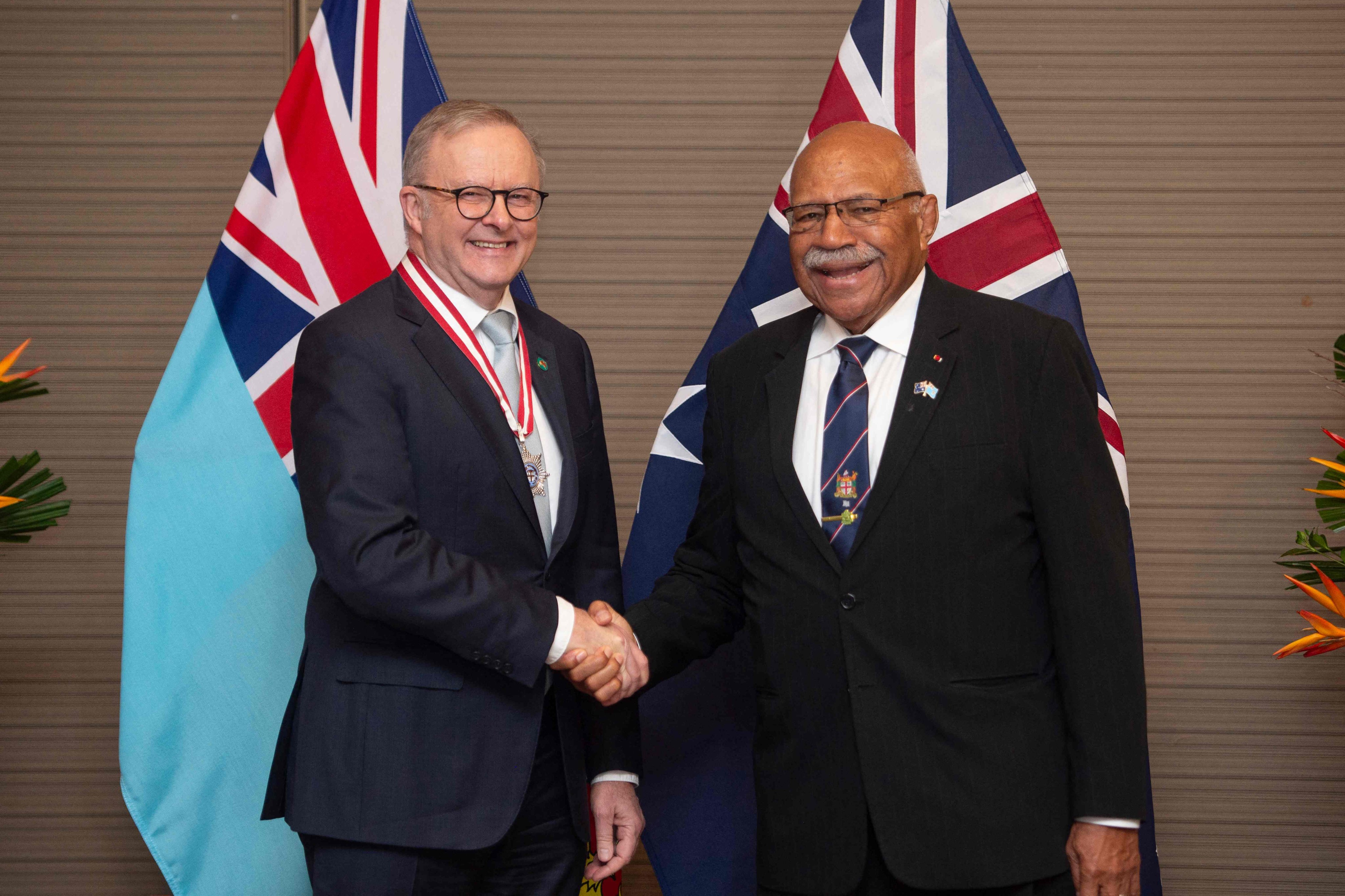 Australian Prime Minister Anthony Albanese shakes hands with Fiji’s Prime Minister Sitiveni Rabuka (right) before the Ocean of Peace Alliance signing on July 6. Photo: AFP