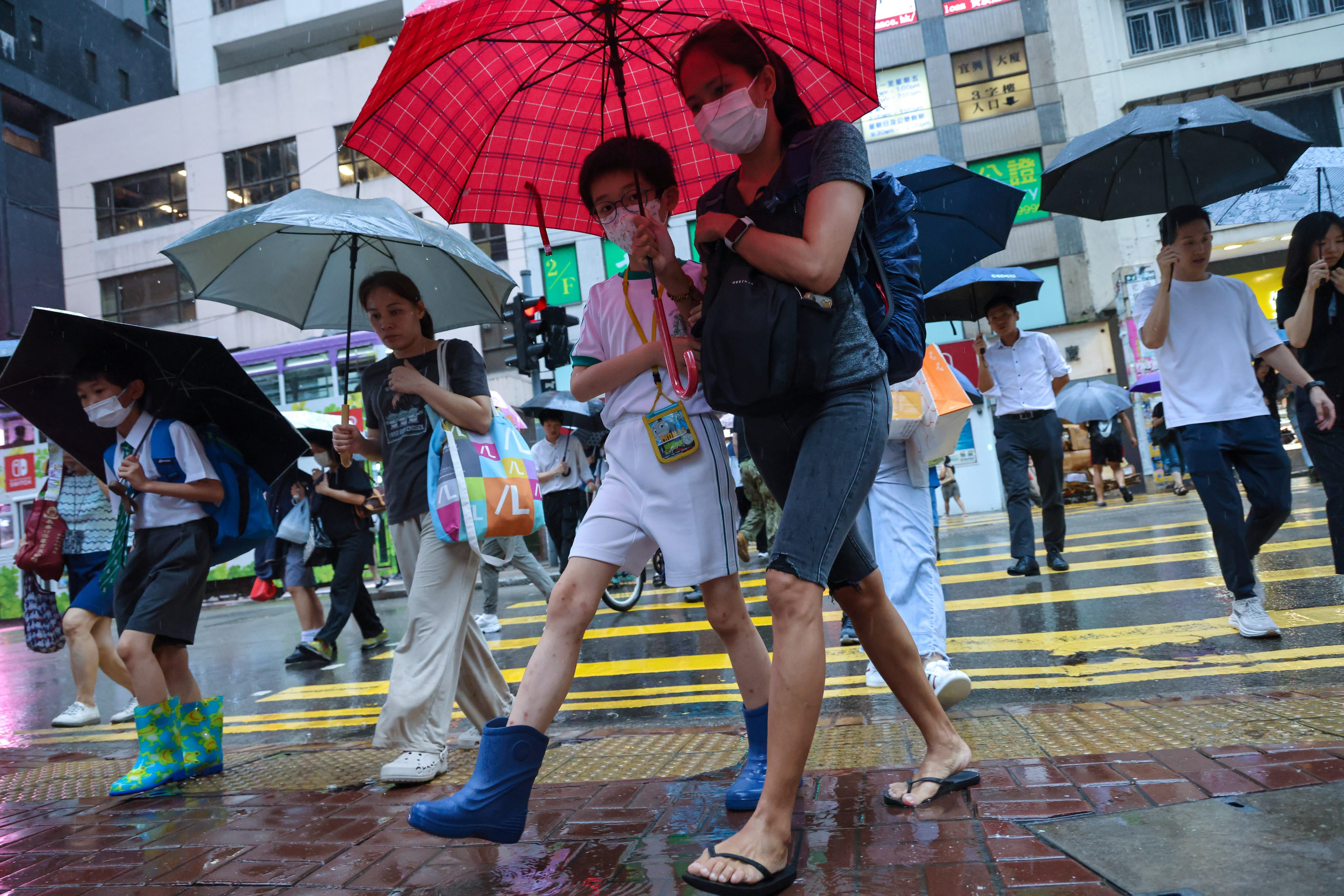 Students brave the heavy rain in Wan Chai last month. Photo: Nora Tam
