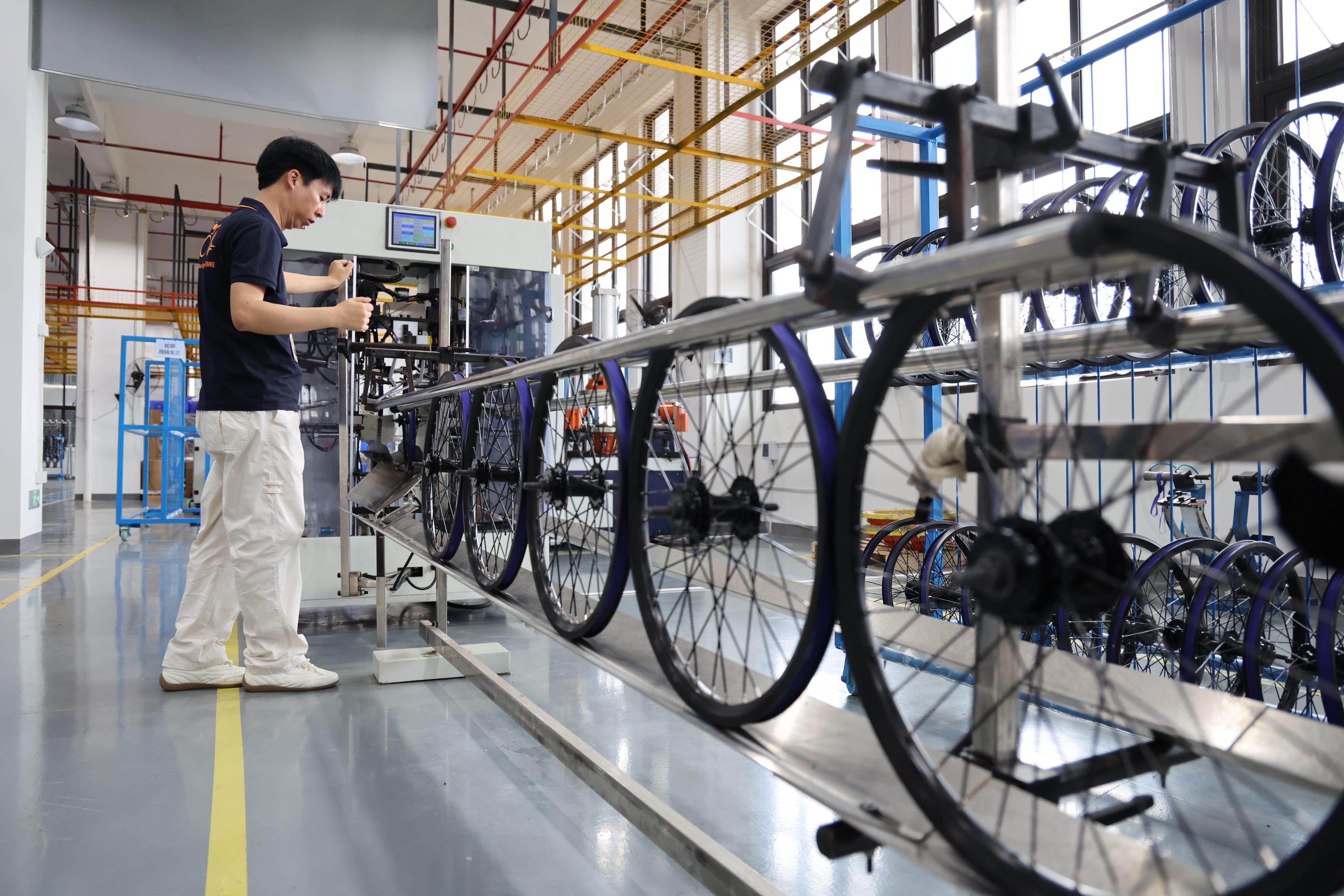 A staff member works at an e-bike workshop in Huizhou, south China’s Guangdong province. Photo: Xinhua