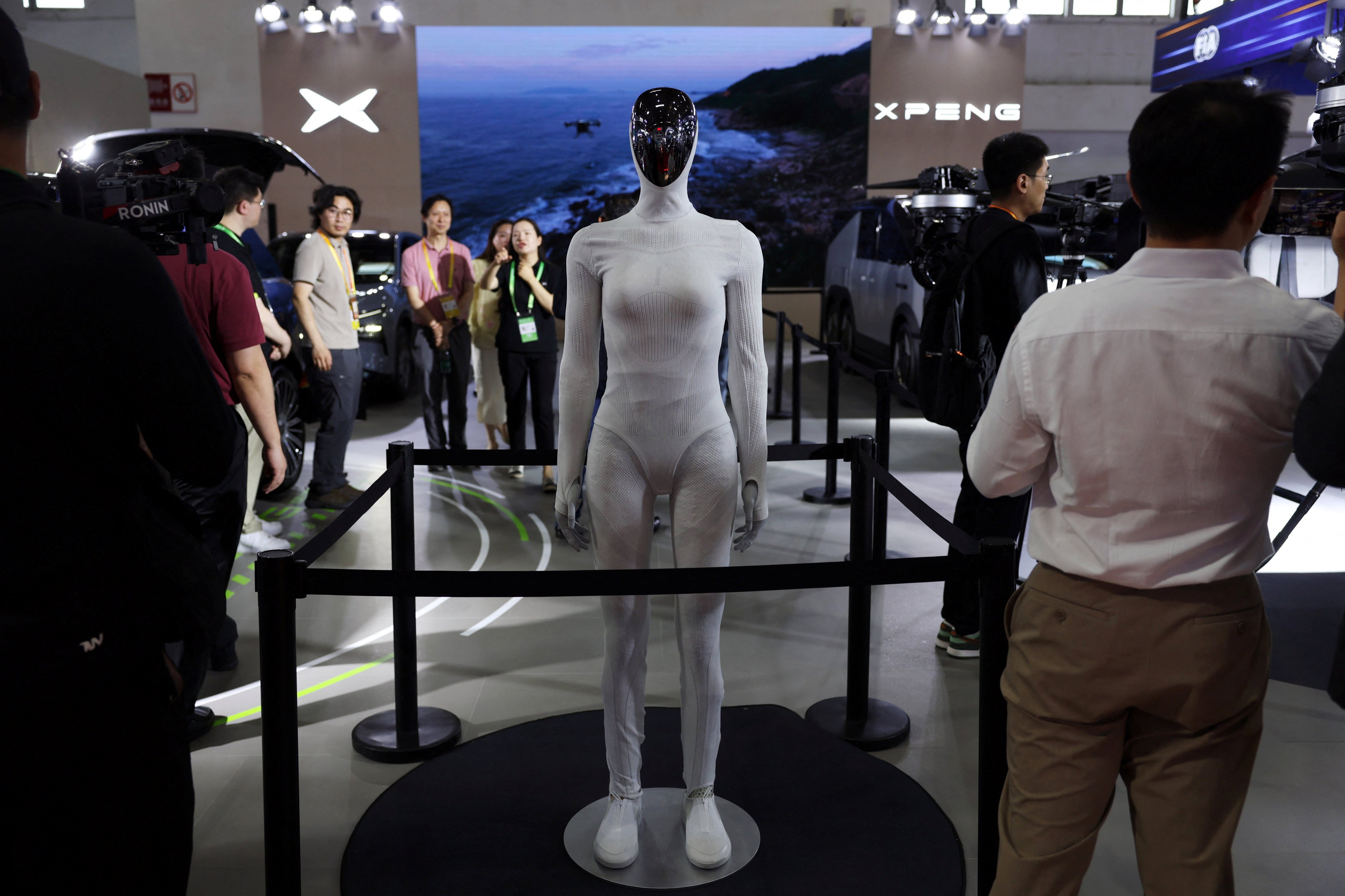 People stand near an Xpeng Iron humanoid robot displayed at the electric vehicle maker’s booth during the China International Supply Chain Expo in Beijing on June 22. Photo: Reuters