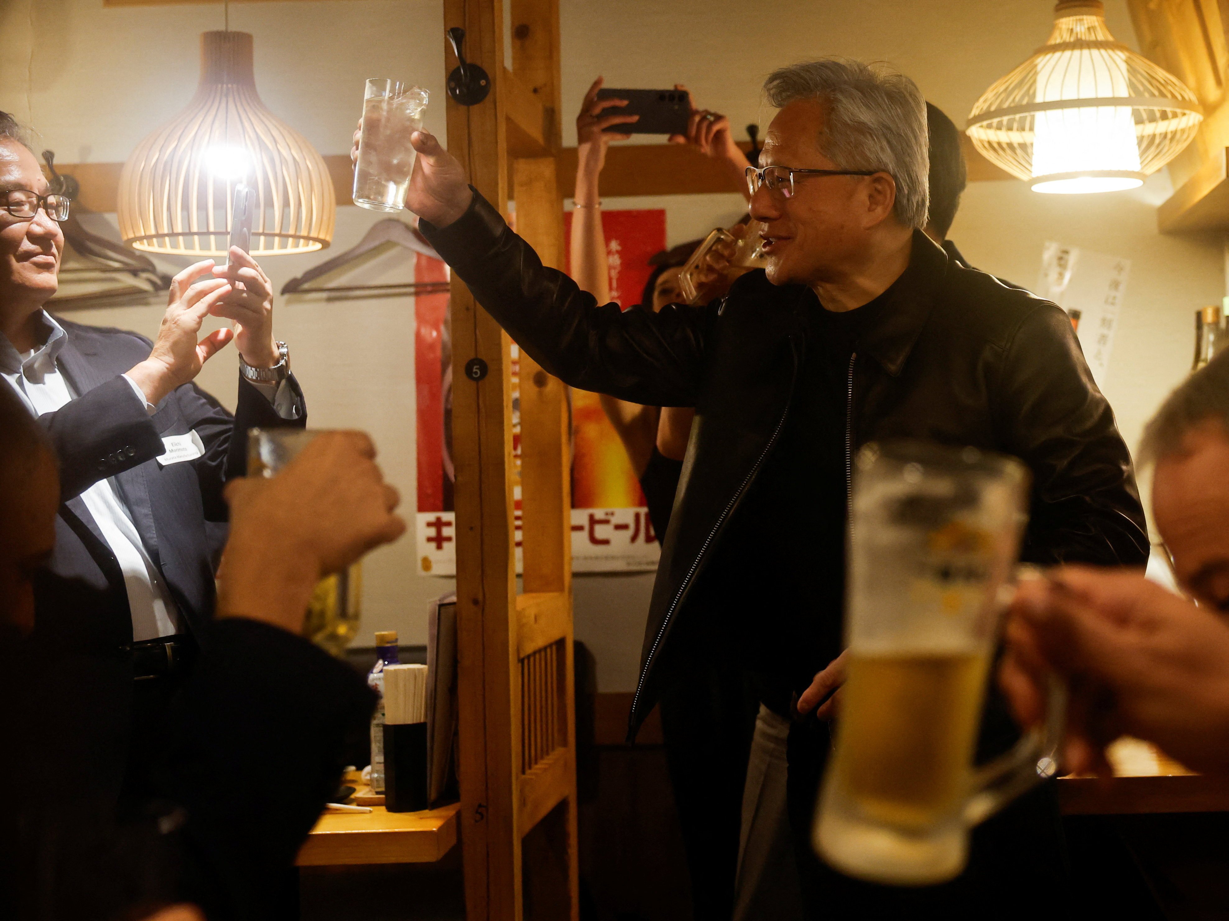 Nvidia CEO Jensen Huang proposes a toast during dinner at an izakaya  in Tokyo on Wednesday. Photo: Reuters