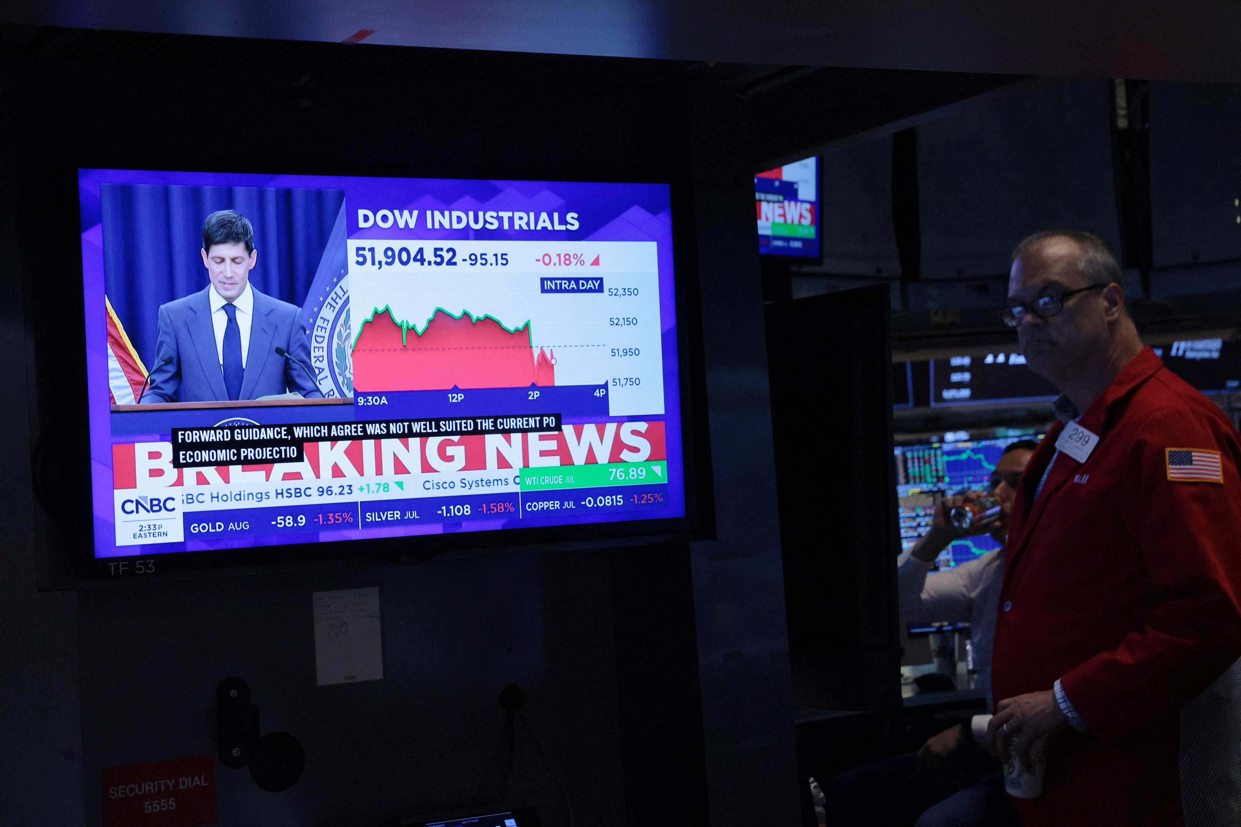 A television displays Kevin Warsh, chairman of the US Federal Reserve, speaking at a press conference as traders work on the floor of the New York Stock Exchange on June 17. Warsh spoke about the Federal Reserve decision to keep interest rates unchanged for the fourth time this year. Photo: AFP