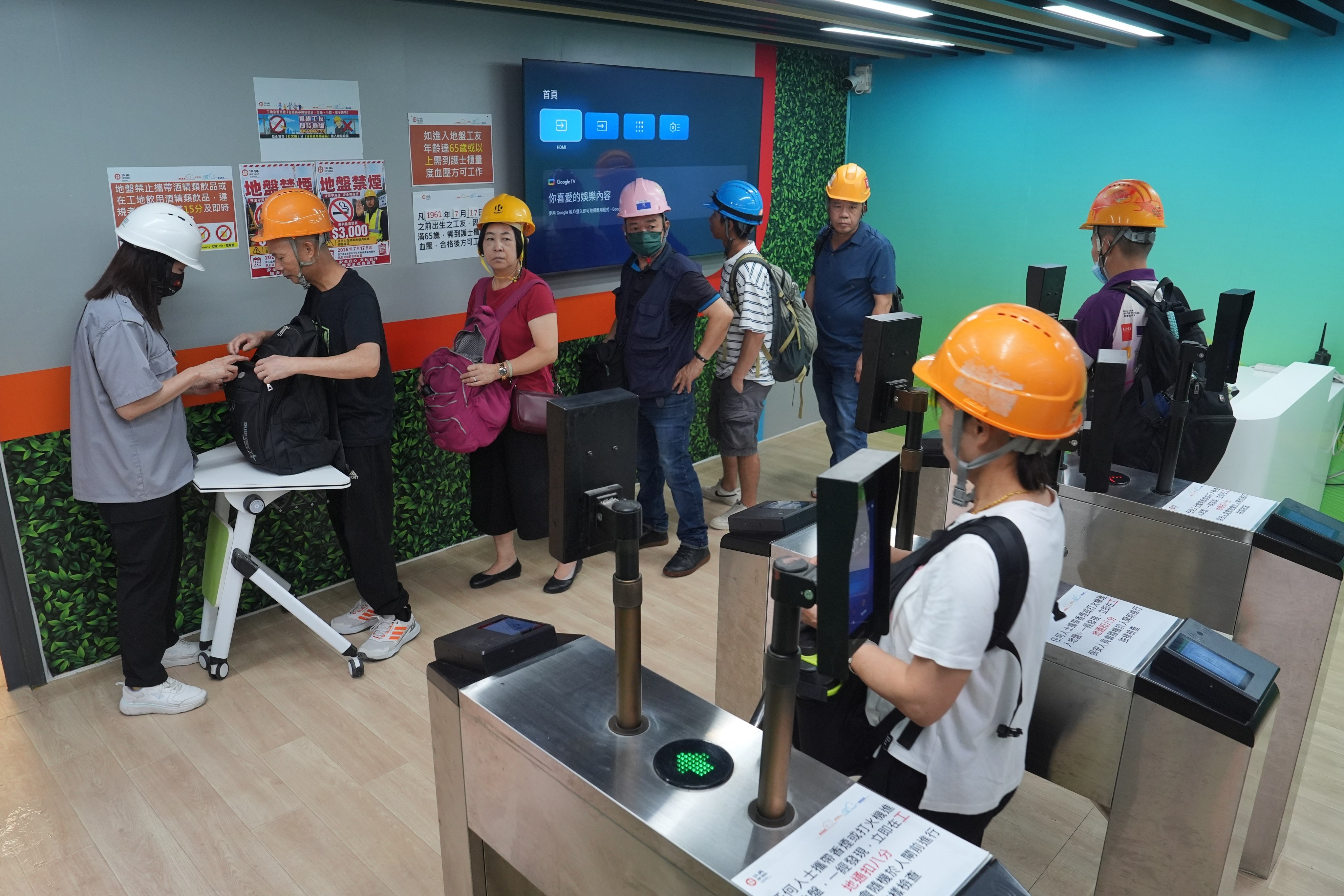Security staff check workers’ bags for smoking items on Friday. Photo: Elson Li