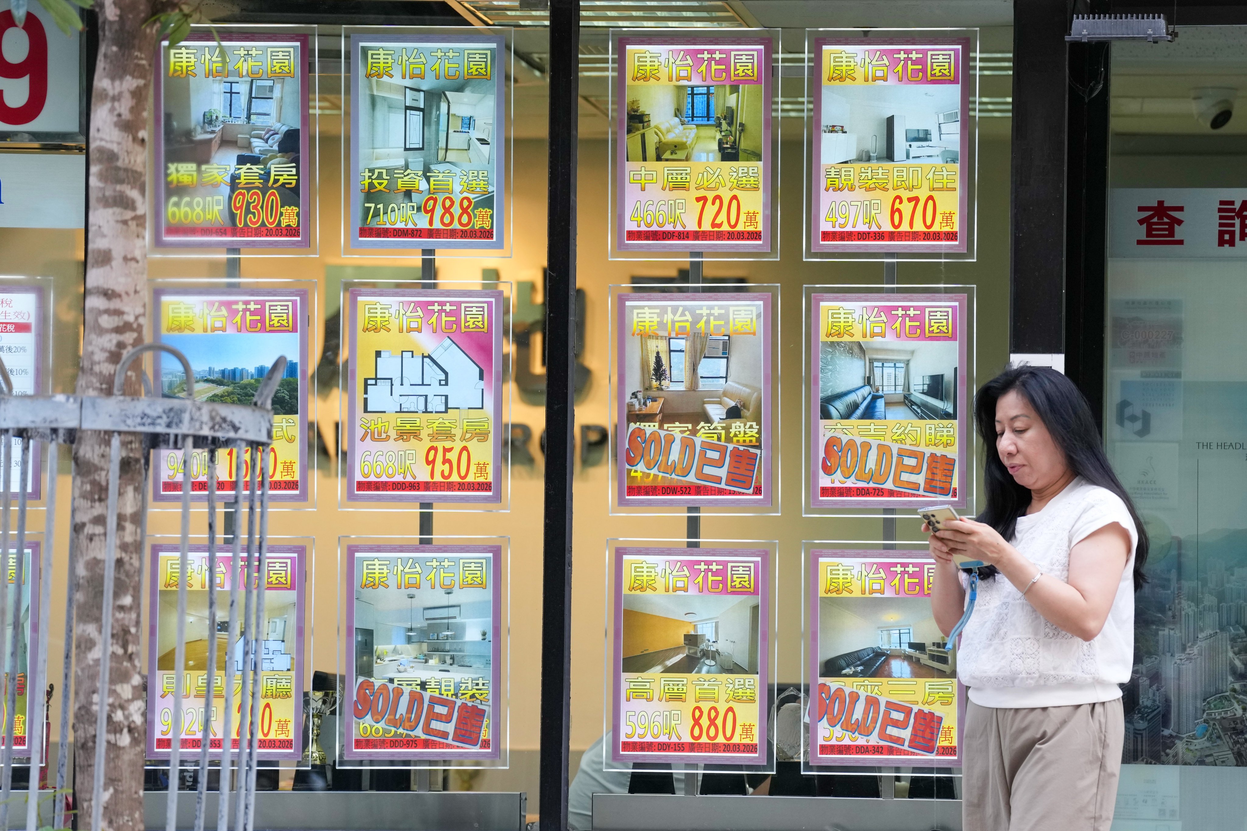 A pedestrian walks past a property agency in Quarry Bay as Hong Kong home prices rise for the 11th straight month on May 27, 2026. Photo: Karma Lo