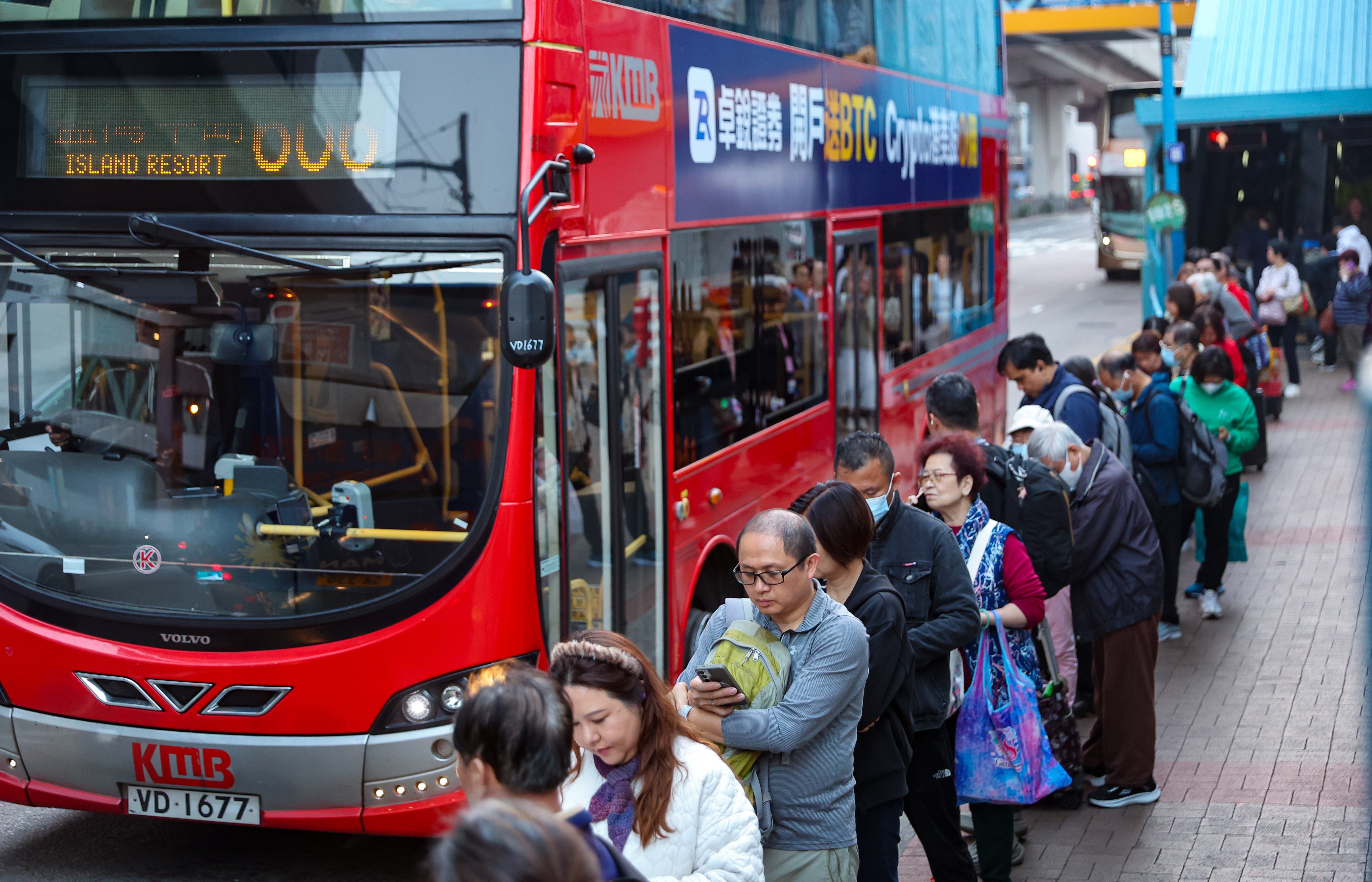 People wait at a bus stop in Kwun Tong. Photo: Edmond So