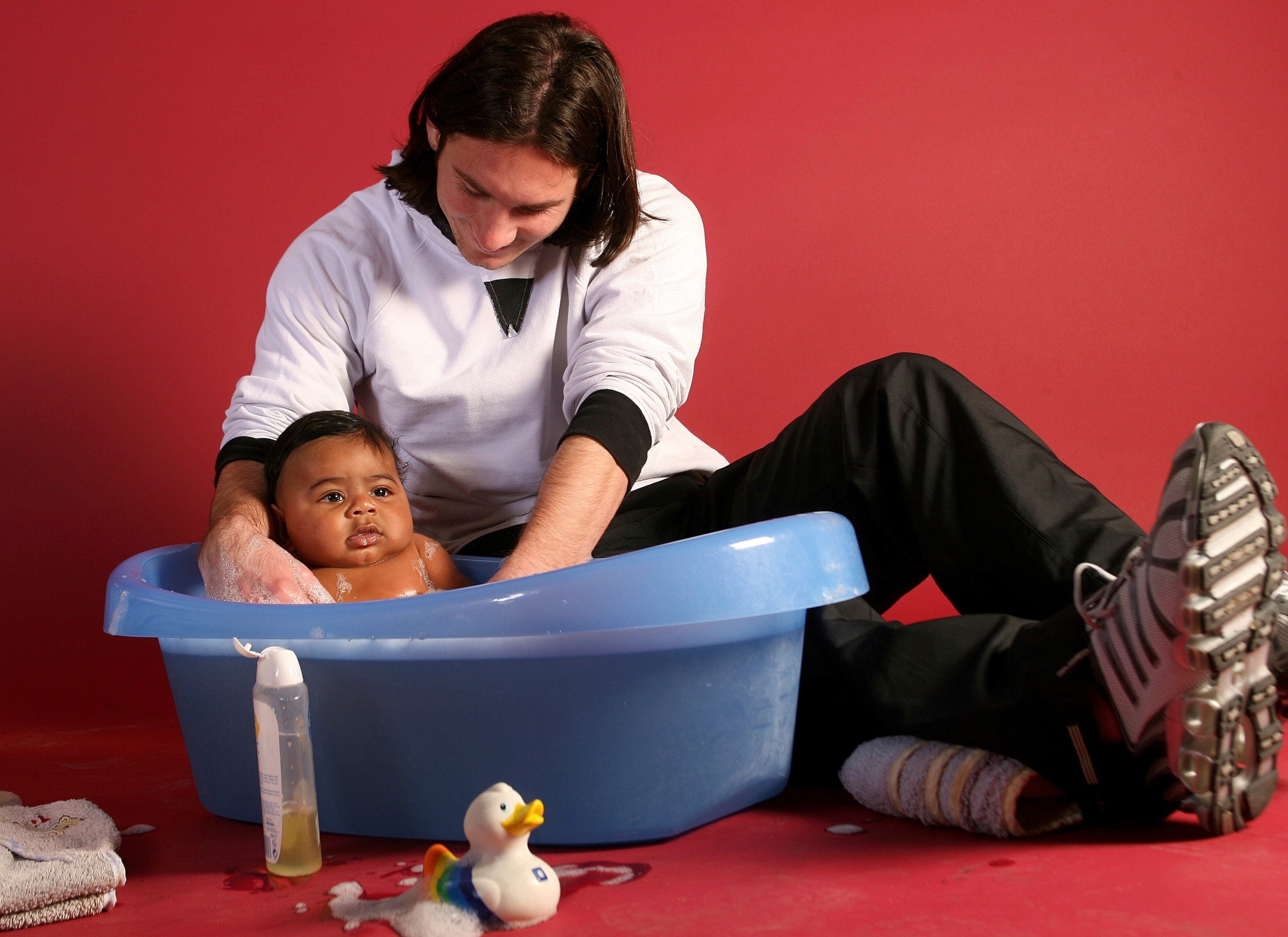 Lionel Messi, then 20, helps to bathe Lamine Yamal, who was six months old, during a photo shoot in the dressing room of Barcelona's Camp Nou stadium in 2007. Photo: AP