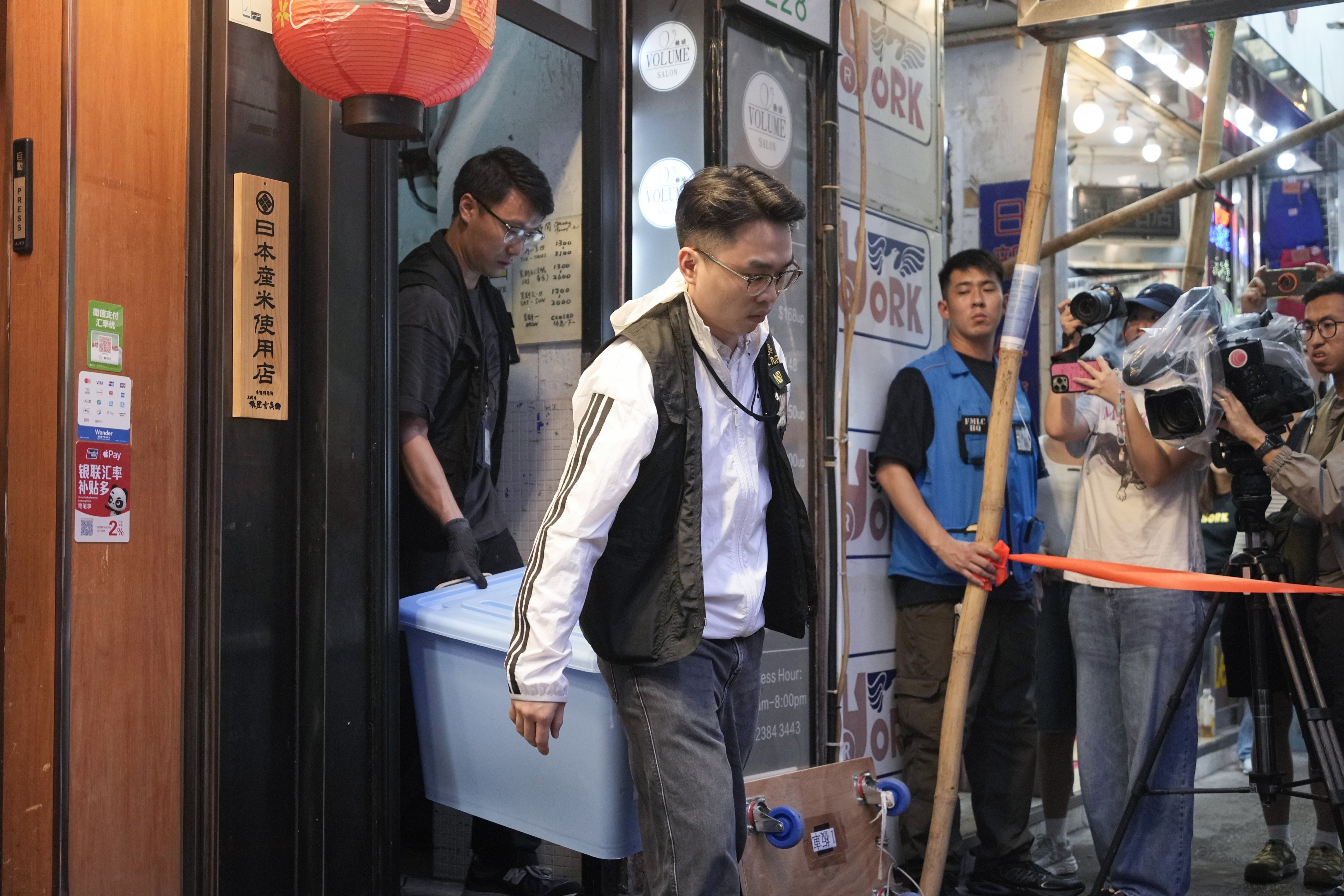 Police officers remove confiscated items after a raid on Have a Nice Stay bookshop in Hong Kong’s Prince Edward neighbourhood. Photo: Handout