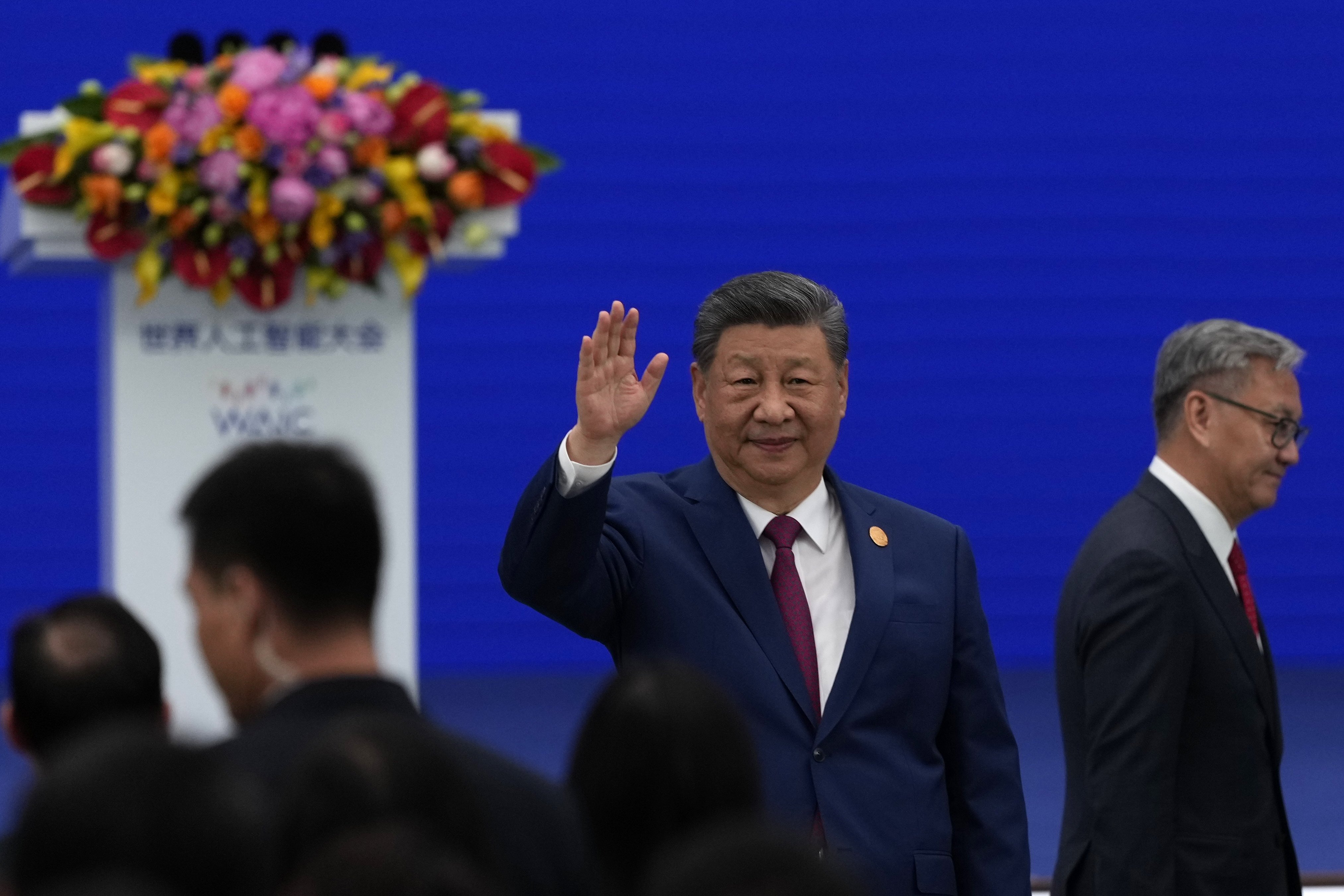 Chinese President Xi Jinping waves as he arrives at the opening ceremony of the World AI Conference in Shanghai. Photo: EPA//Pool