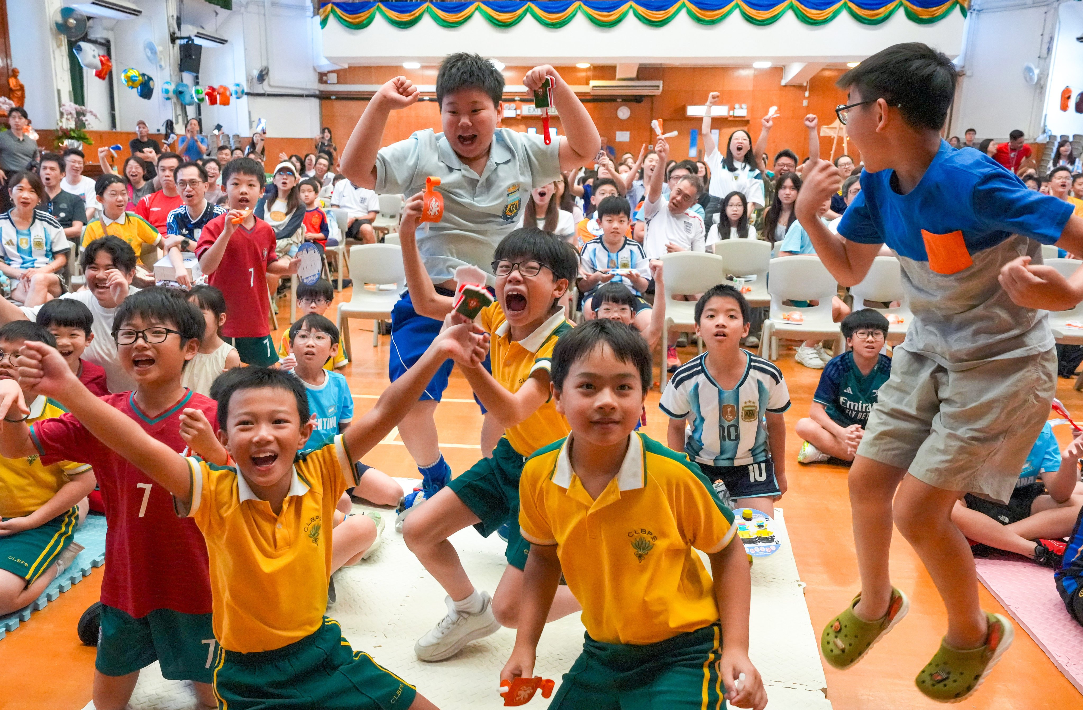 Buddhist Chi Lin Primary School’s “World Cup Round of 16 Family Fun Day” in Tseung Kwan O, Hong Kong, on July 12, with students and their parents cheering for their favourite team during the Argentina vs Switzerland game. Photo: Dickson Lee
