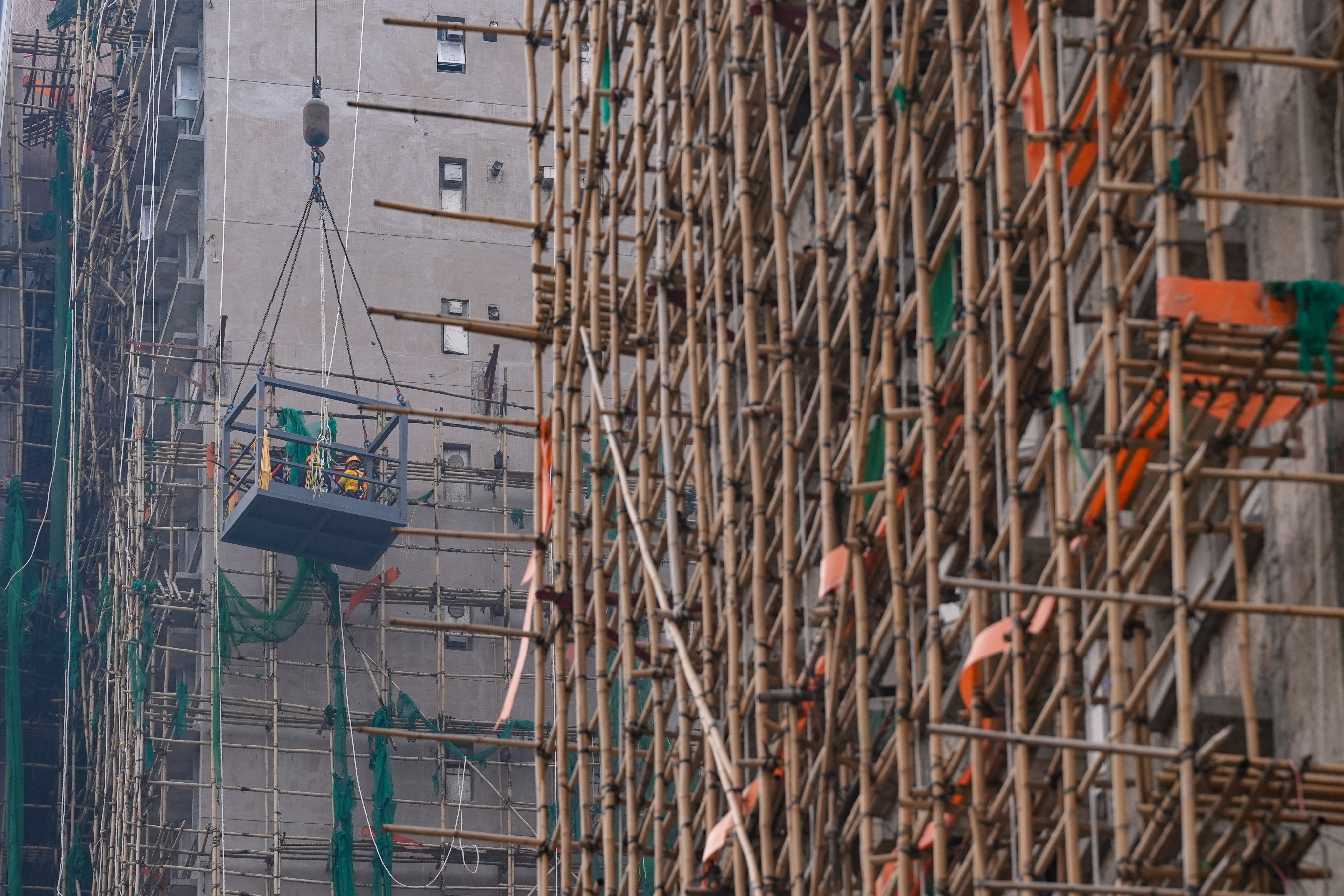 Bamboo scaffolding on the exterior of the Wang Fuk Court towers in January. Photo: Elson Li