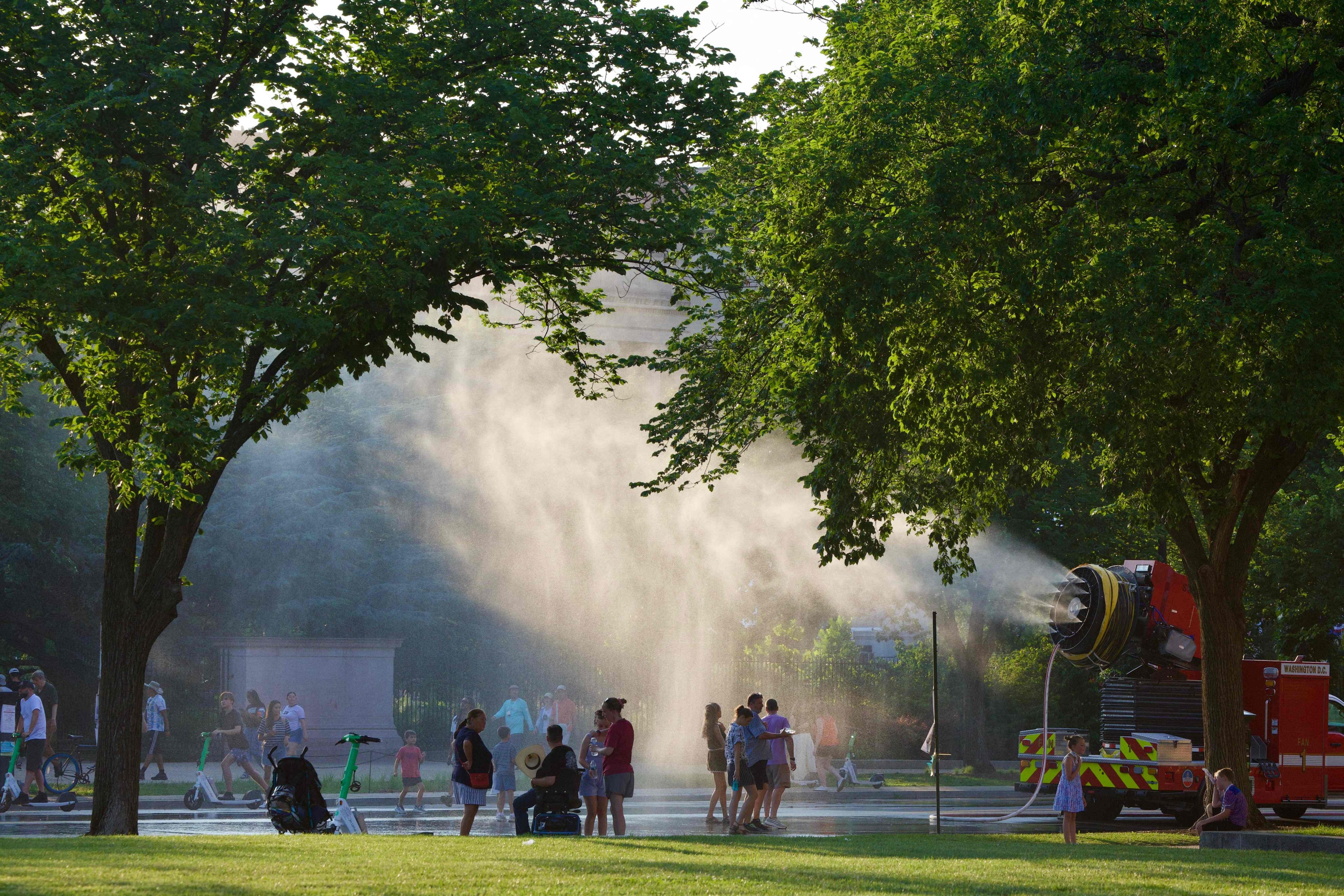People battle the heat with misting stations along the National Mall in Washington on July 3. Photo: AFP