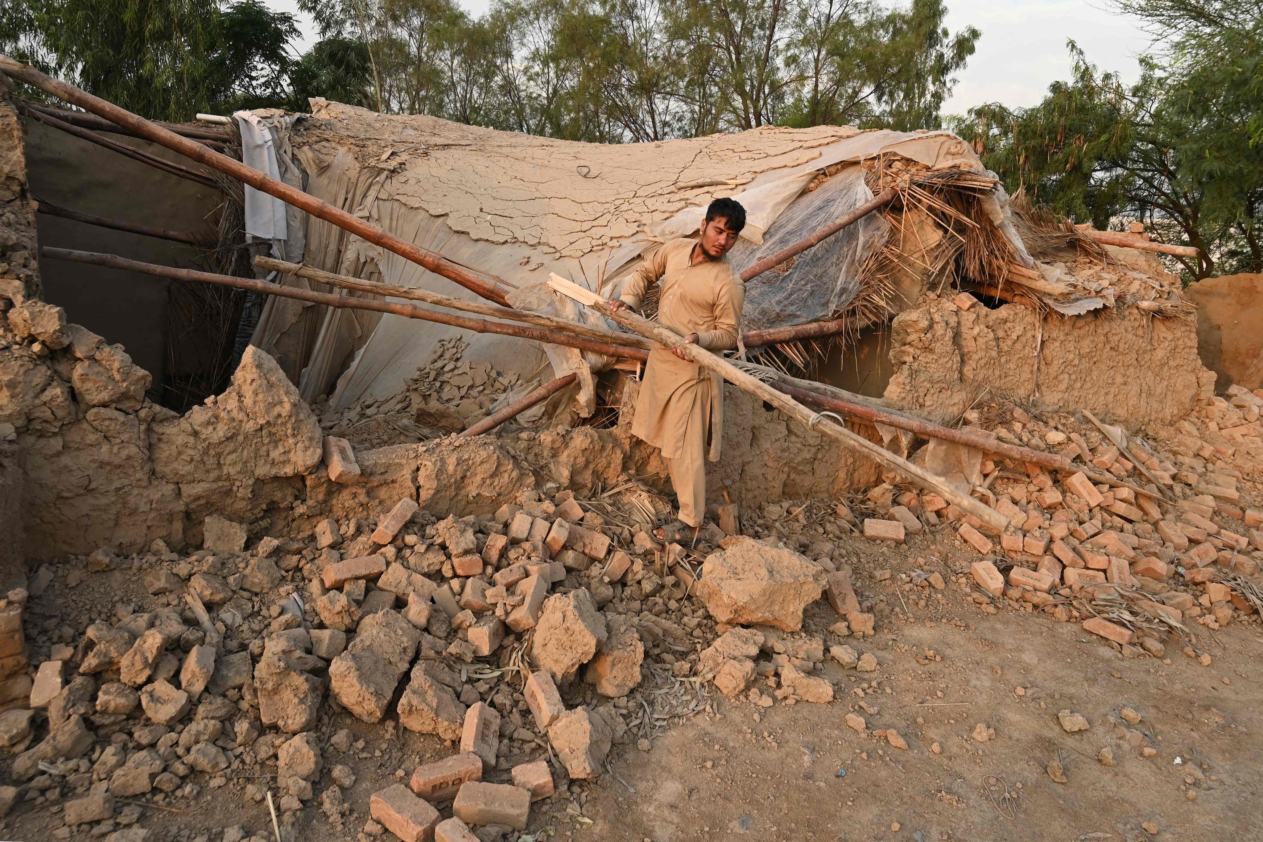 A man collects building materials in Peshawar before his repatriation to Afghanistan on Tuesday. Photo: AFP