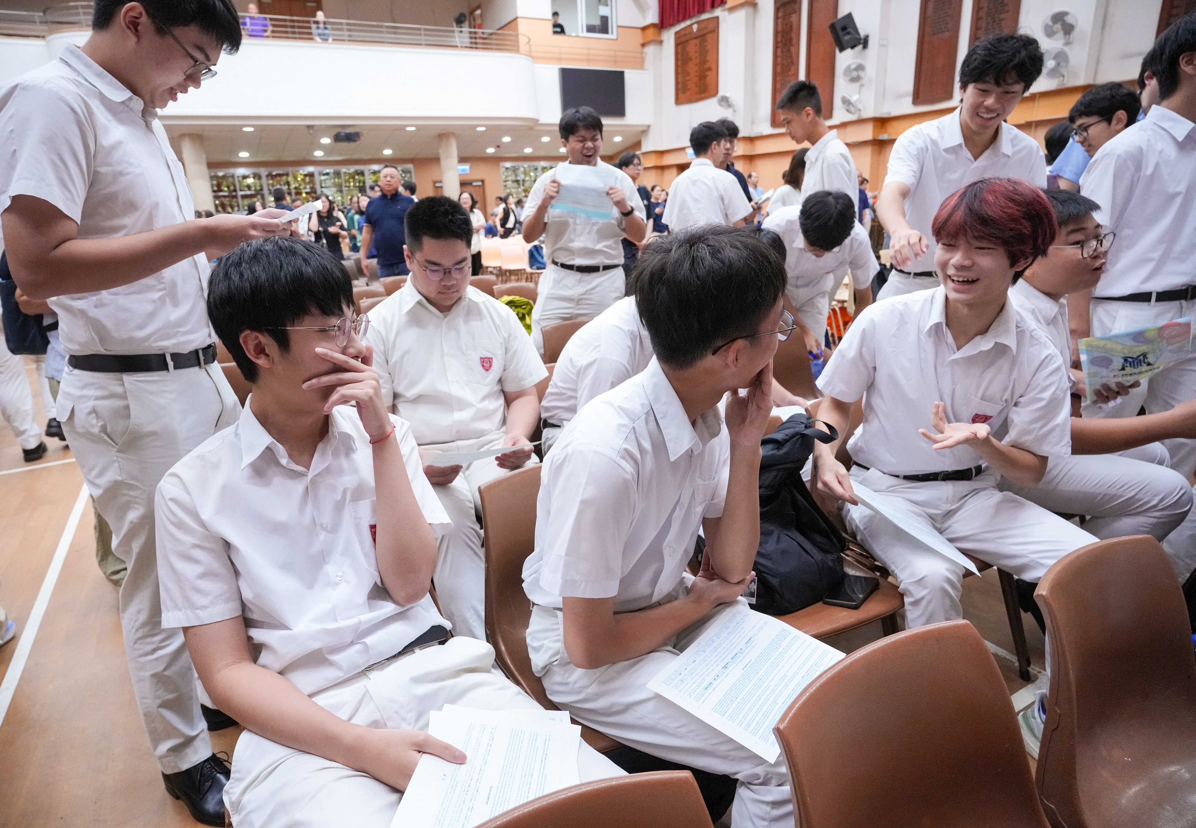 Students from Queen’s College receive their results for the DSE exams. Photo: May Tse