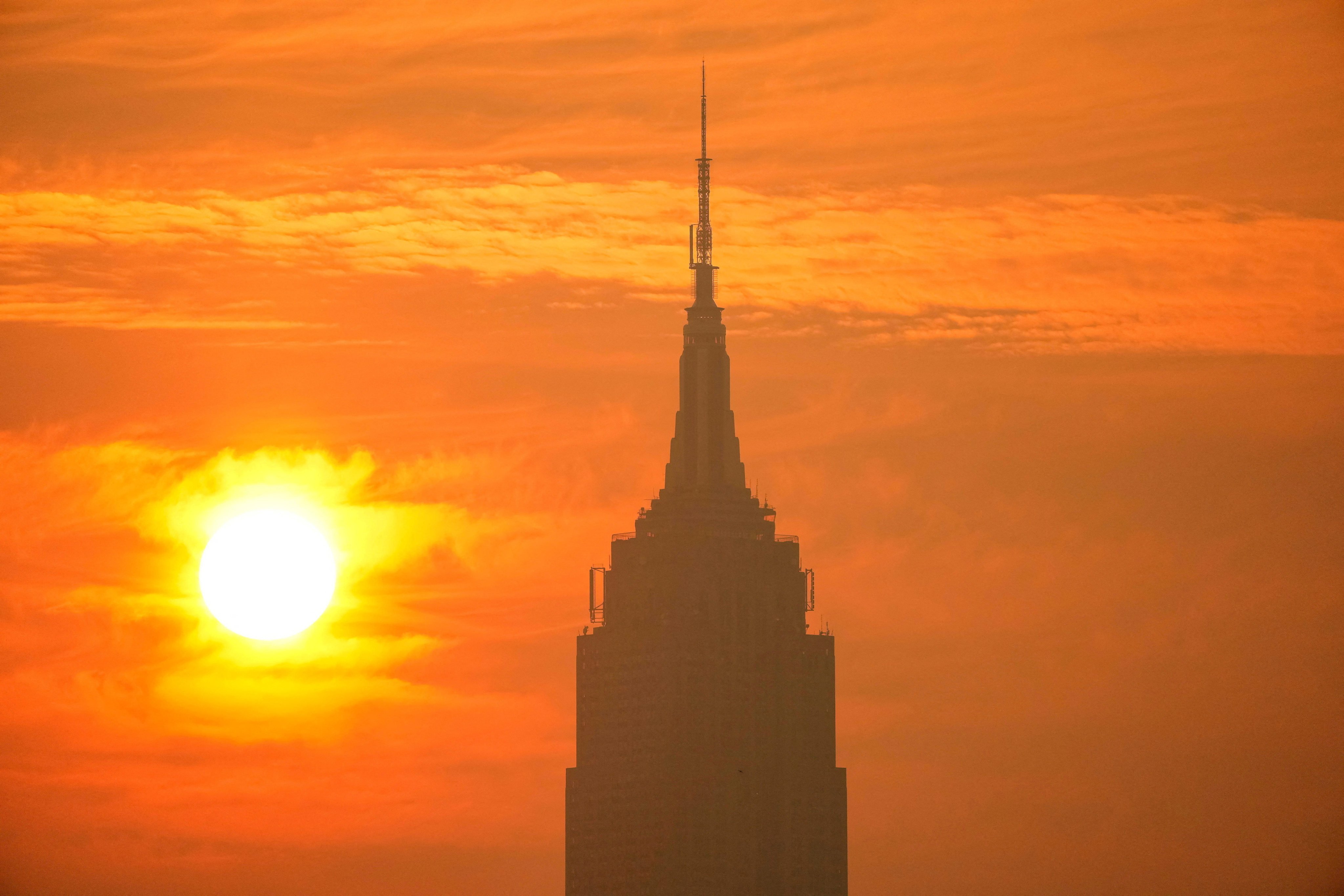 The sun rises next to The Empire State Building through a cover of wildfire smoke on Friday. Photo: Reuters