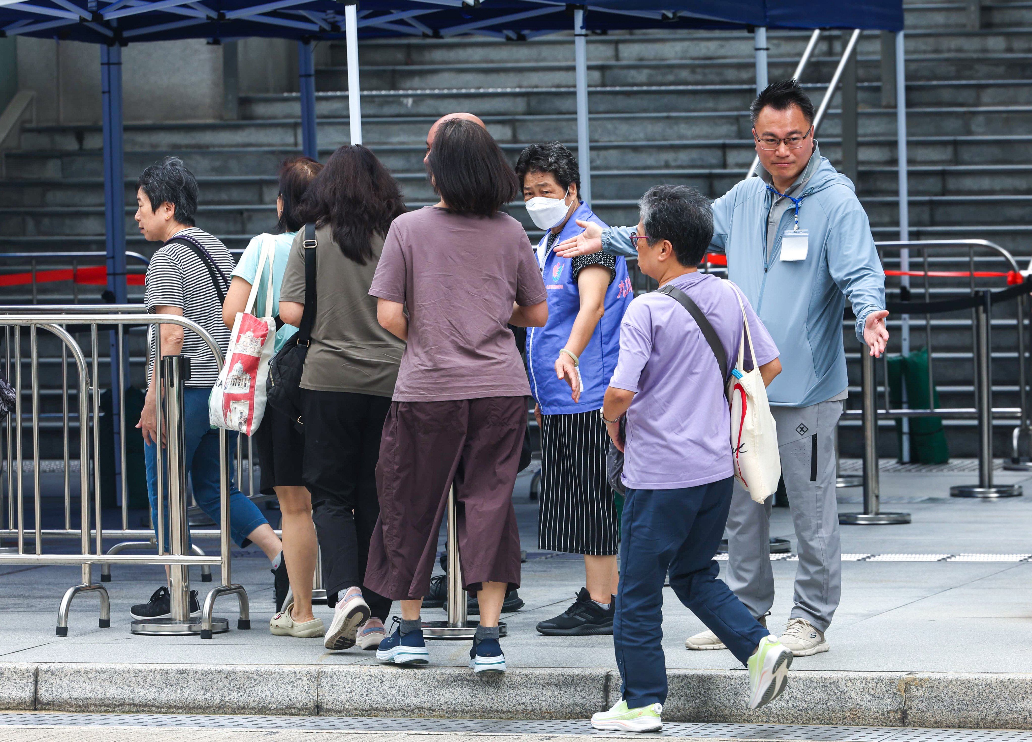 Homeowners arrive for the meeting at the Kai Tak Community Hall. Photo: Edmond So
