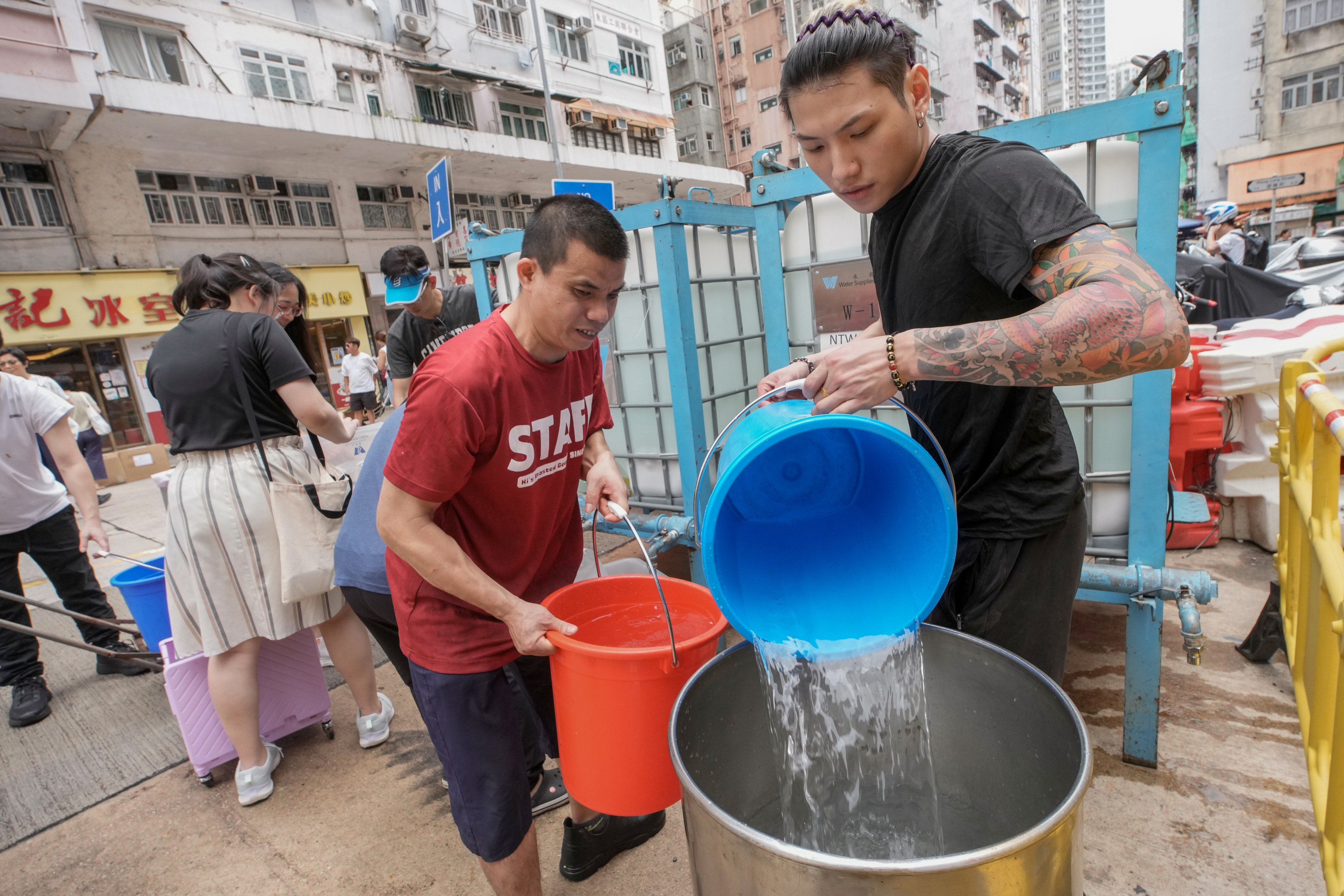 Residents in Shau Kei Wan and Sai Wan Ho fetch water from the tanks. Photo: Dickson Lee