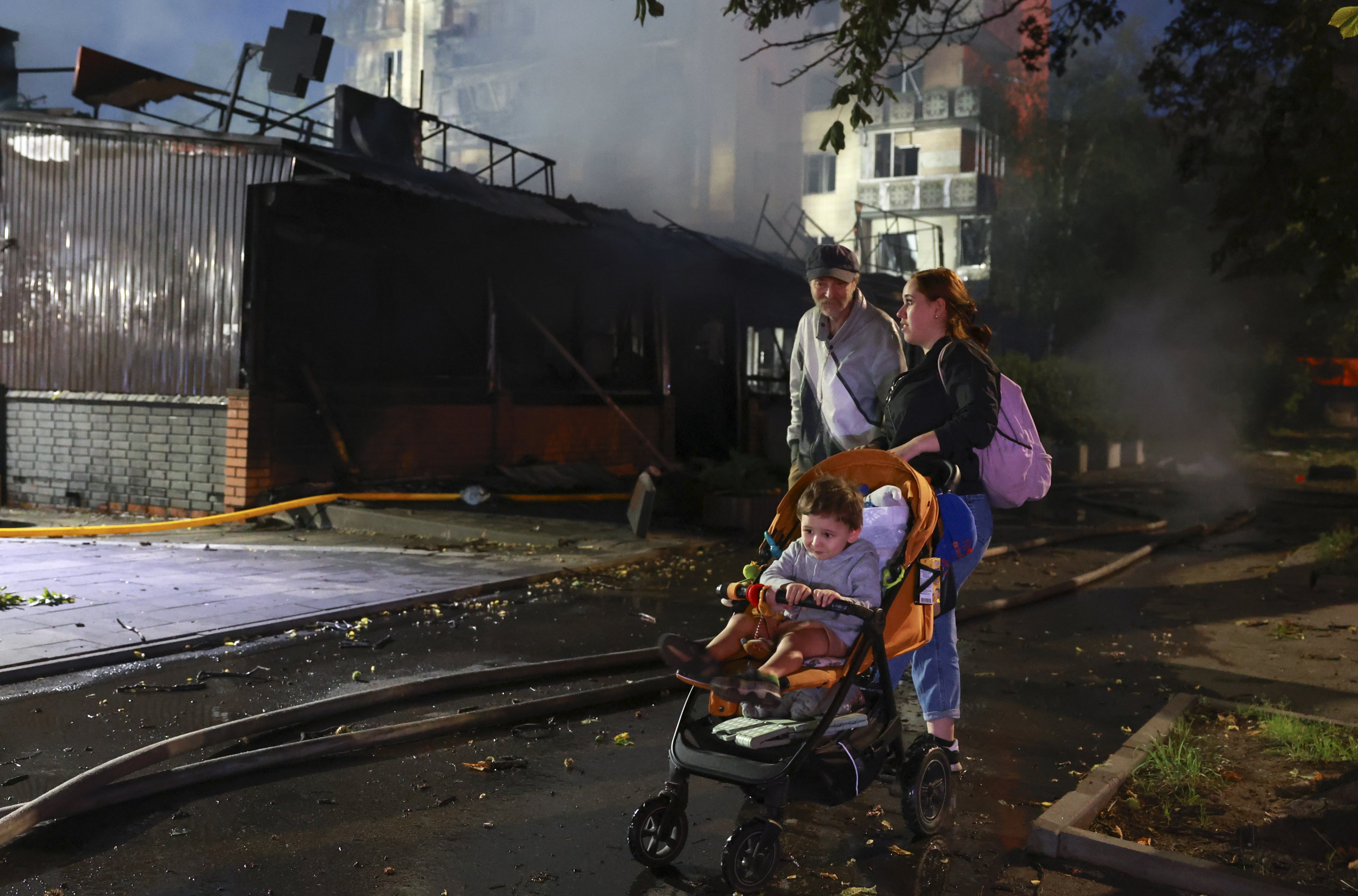 People inspect the site of a Russian missile strike on a residential area in Kyiv, Ukraine, on Sunday. Photo: EPA-EFE