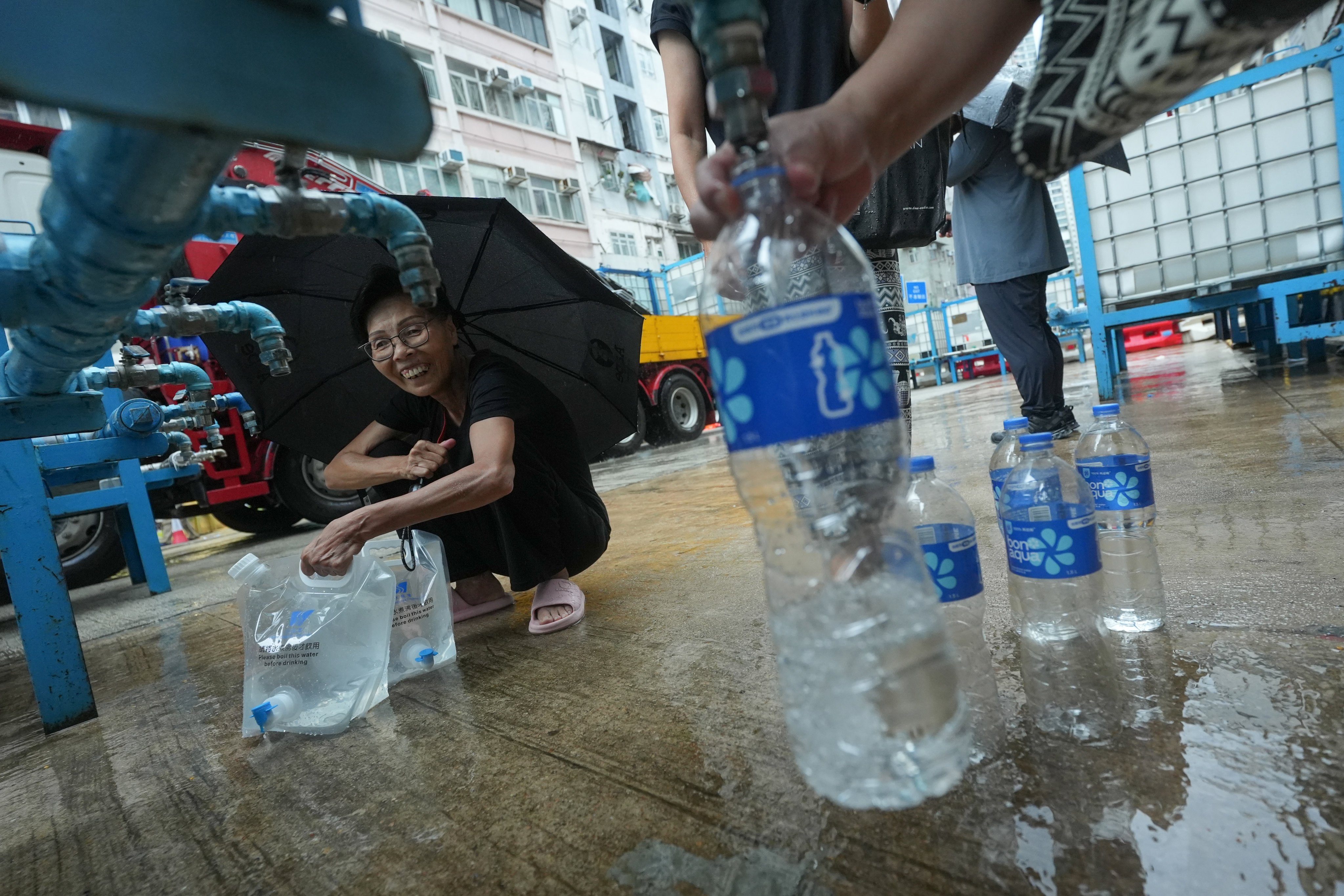 Residents line up to fill water bottles and buckets in Shau Kei Wan. Photo: Sun Yeung