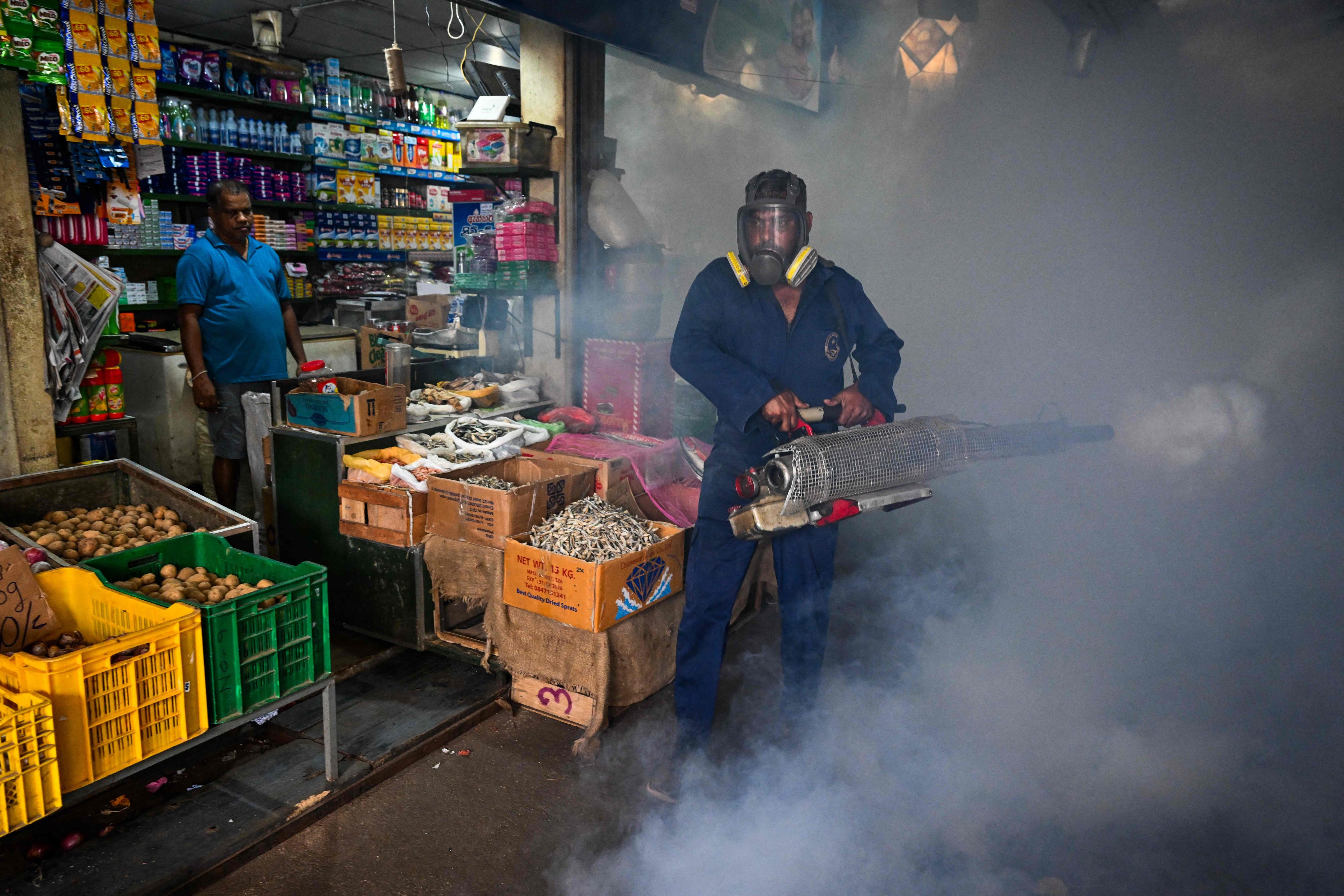 A municipal worker fumigates a market area  in Colombo on Wednesday. Photo: AFP
