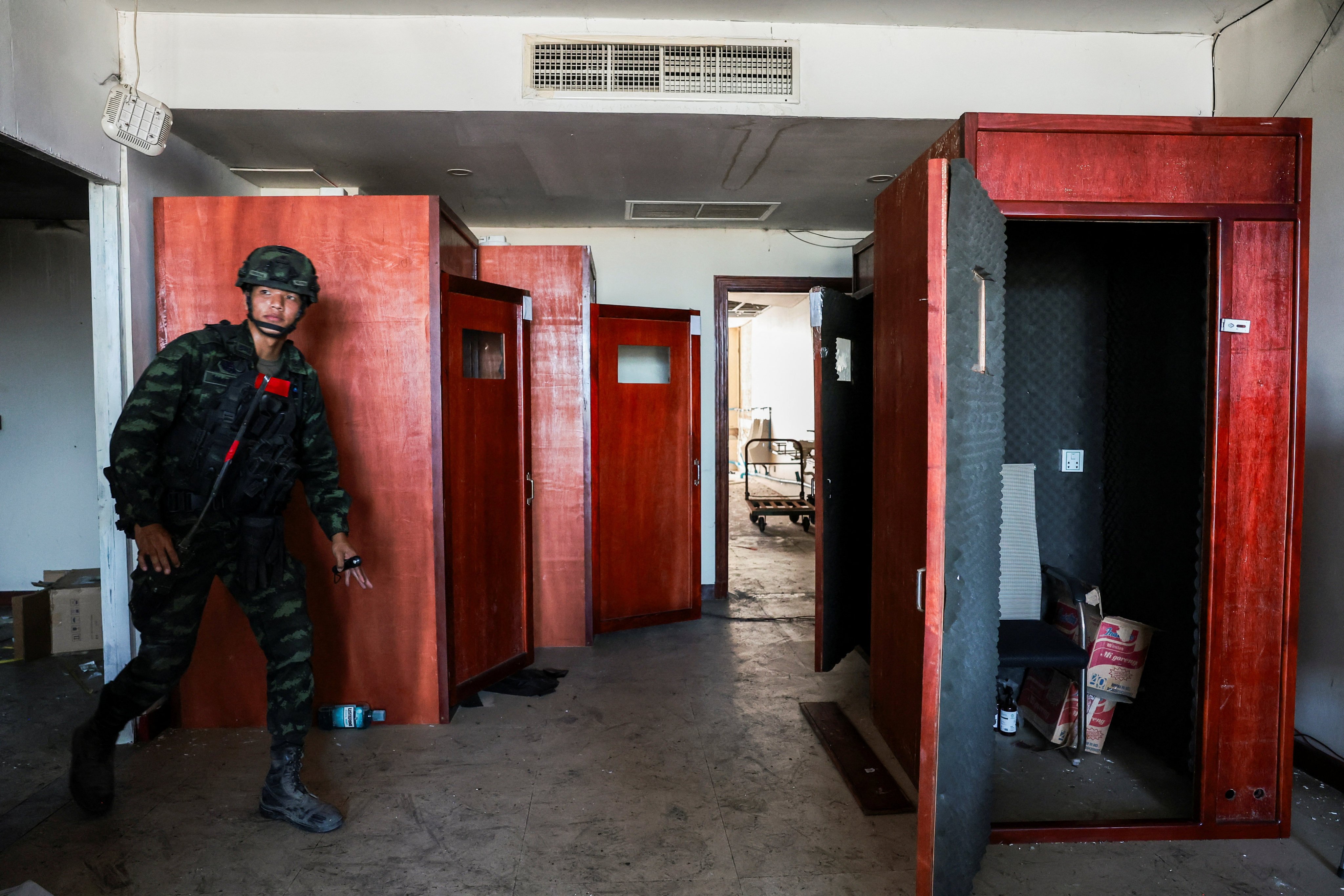A Thai soldier walks near small booths lined with acoustic foam used to make scam calls inside a compound in Cambodia’s O’Smach border town on February 2. Photo: Reuters