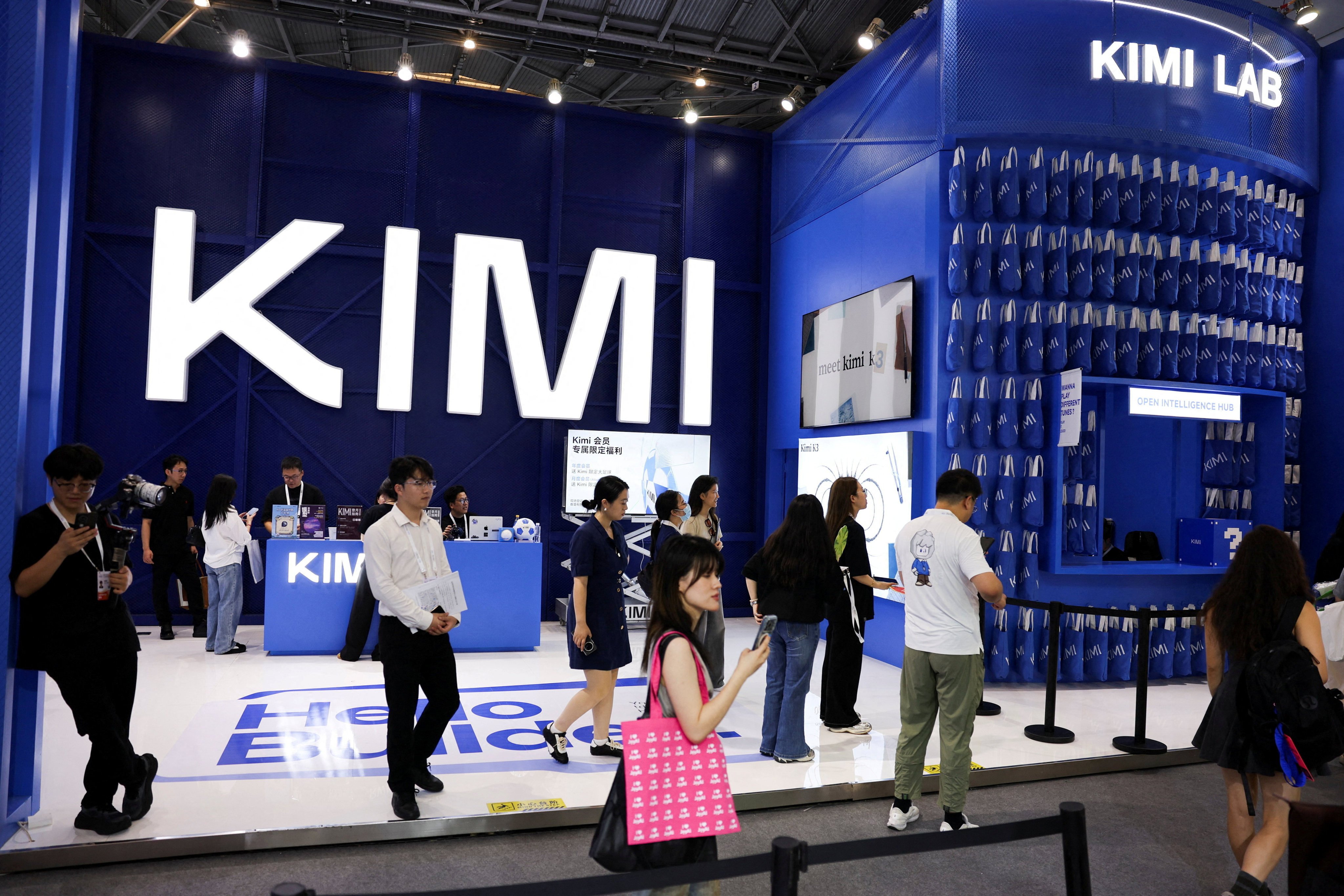 People walk past the Moonshot booth promoting its Kimi K3 AI model during the World Artificial Intelligence Conference in Shanghai on July 17. Photo: Reuters
