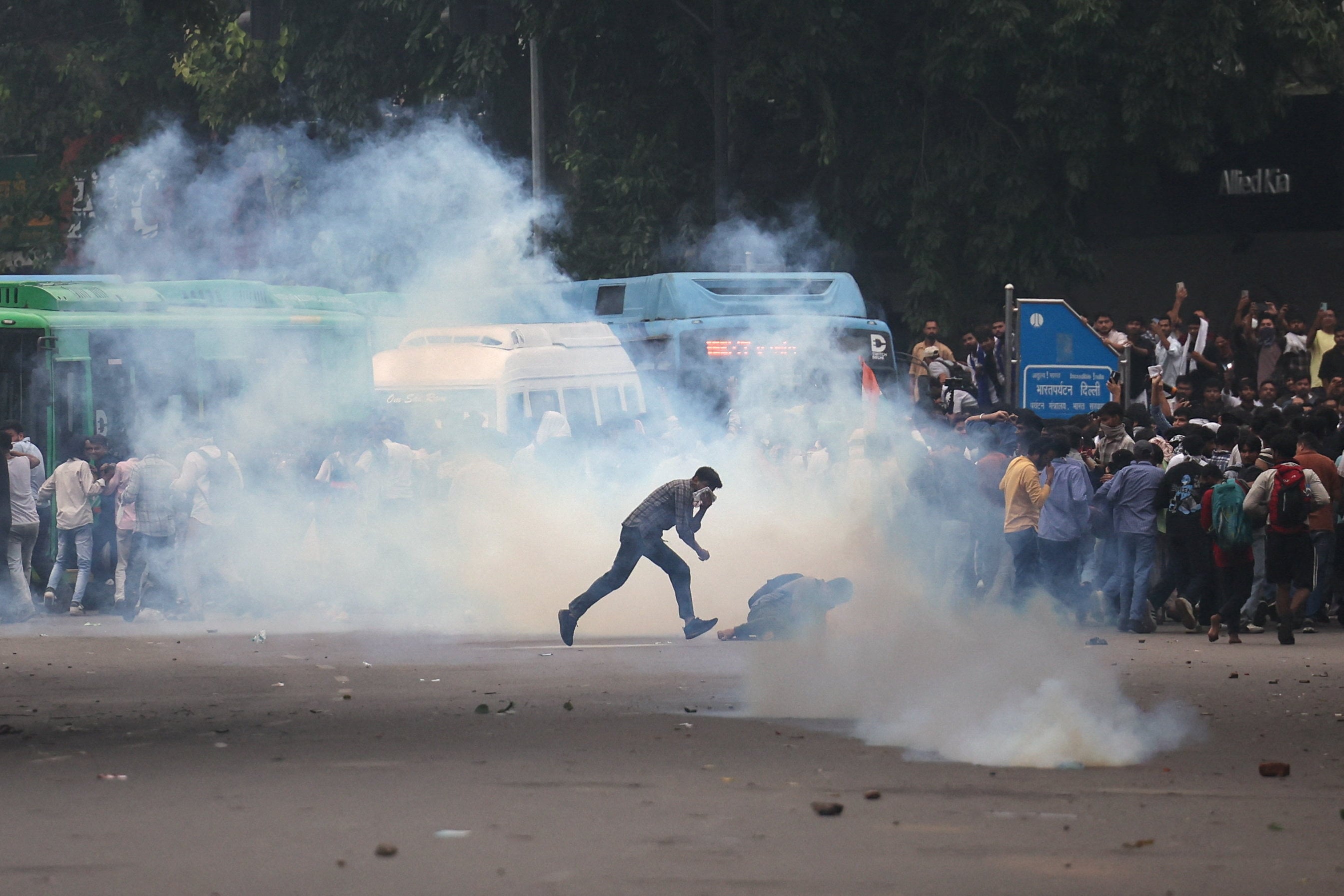 Tear gas spreads around protesters as supporters of India’s Cockroach Janta Party demonstrate on the opening day of the Indian parliament’s monsoon session, demanding the resignation of Education Minister Dharmendra Pradhan over exam paper leaks, in New Delhi, India. Photo: Reuters