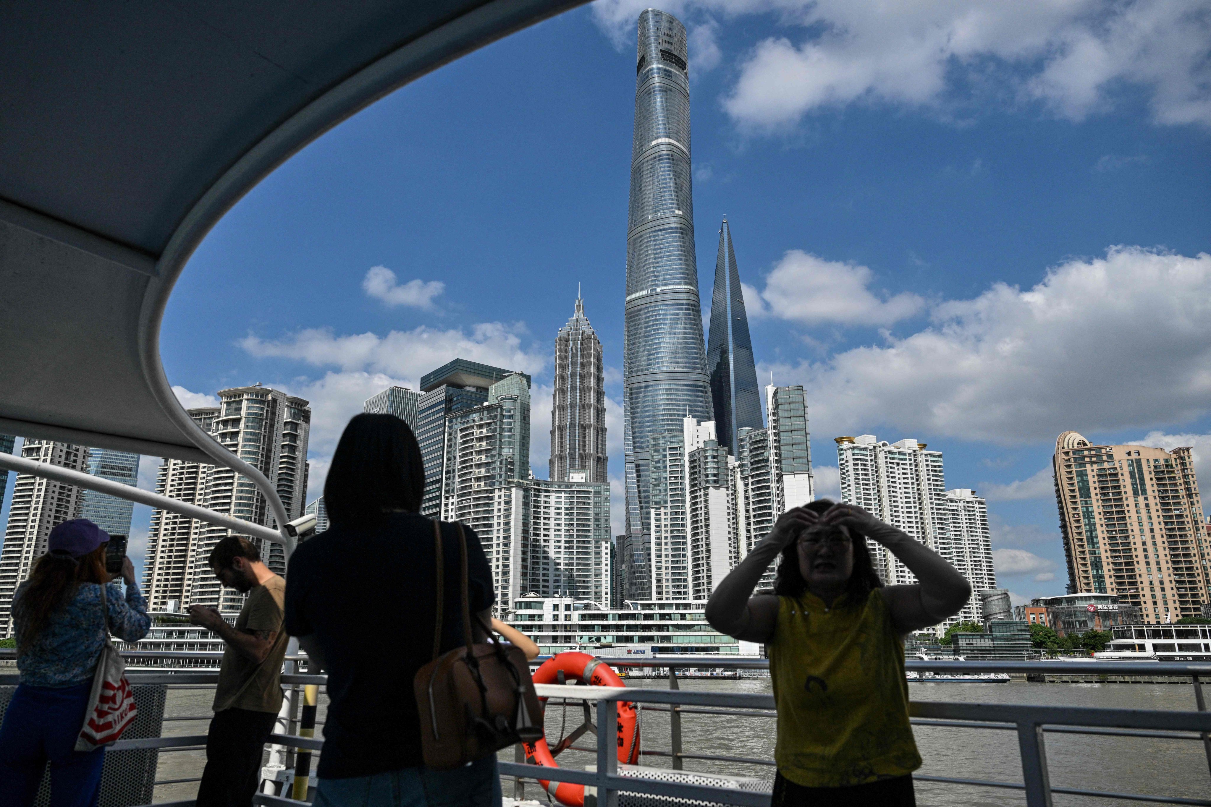 People sail on a ferry on the Huangpu River past the financial district of Lujiazui in Shanghai on September 23, 2024. Photo: AFP