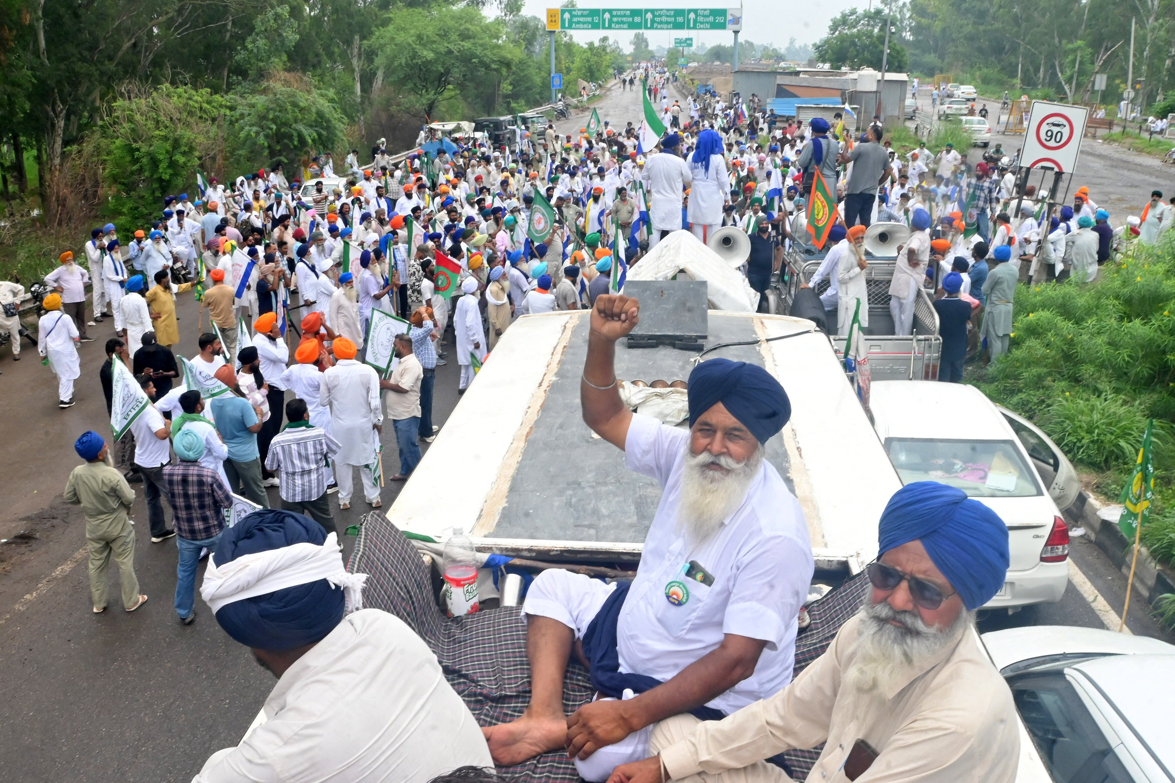 Farmers gather on a highway in Punjab, India on Tuesday after police seal a border crossing to prevent them from proceeding towards New Delhi, where thousands are protesting against a potential US-India trade deal. Photo: Reuters