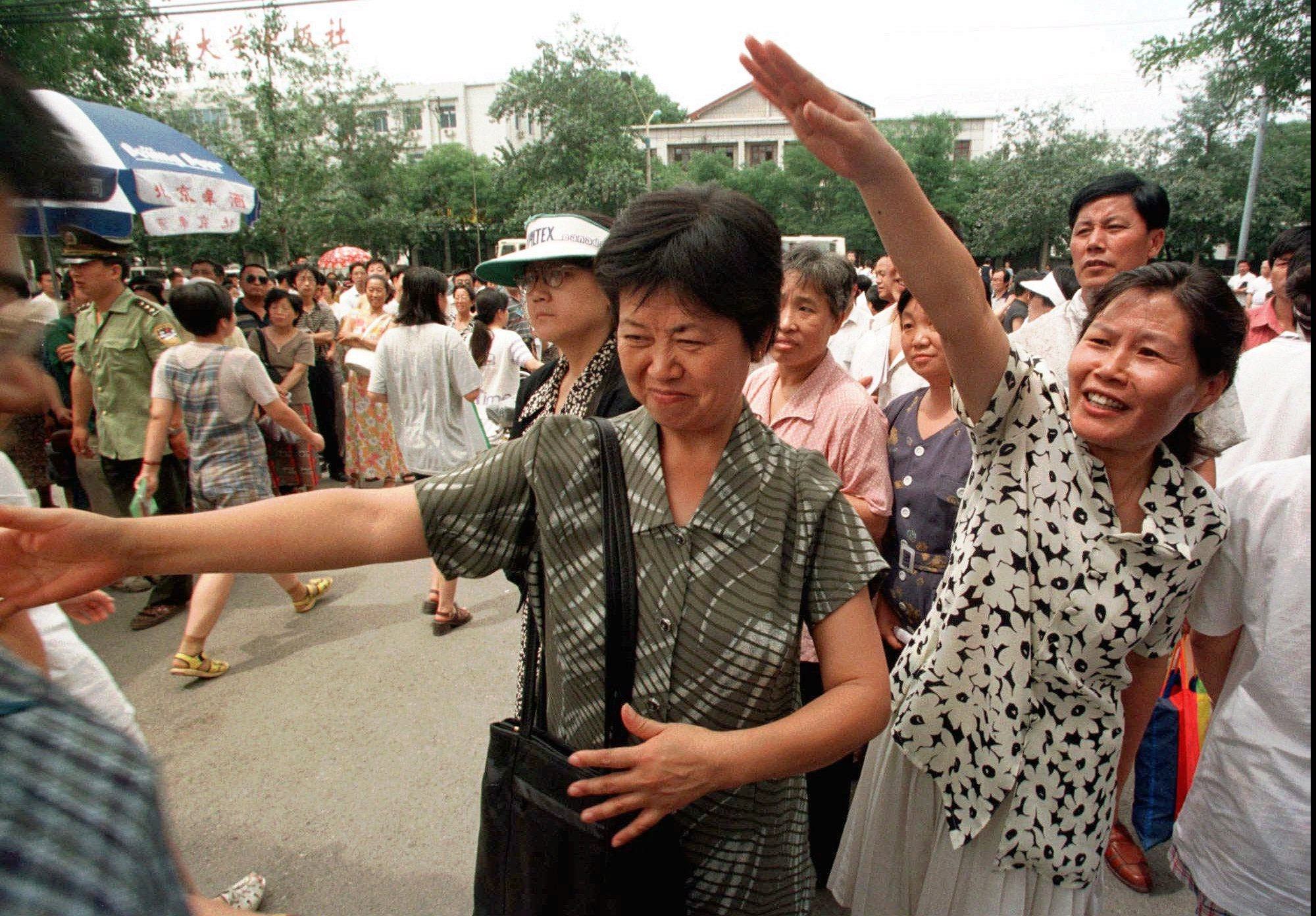 Anxious parents wave as their children emerge from the National Higher Education Entrance Examination at a high school in Beijing in 1998. In Chinese society in the 1980s and 1990s, the self-sacrificing mother could be seen and heard everywhere. Photo: AP