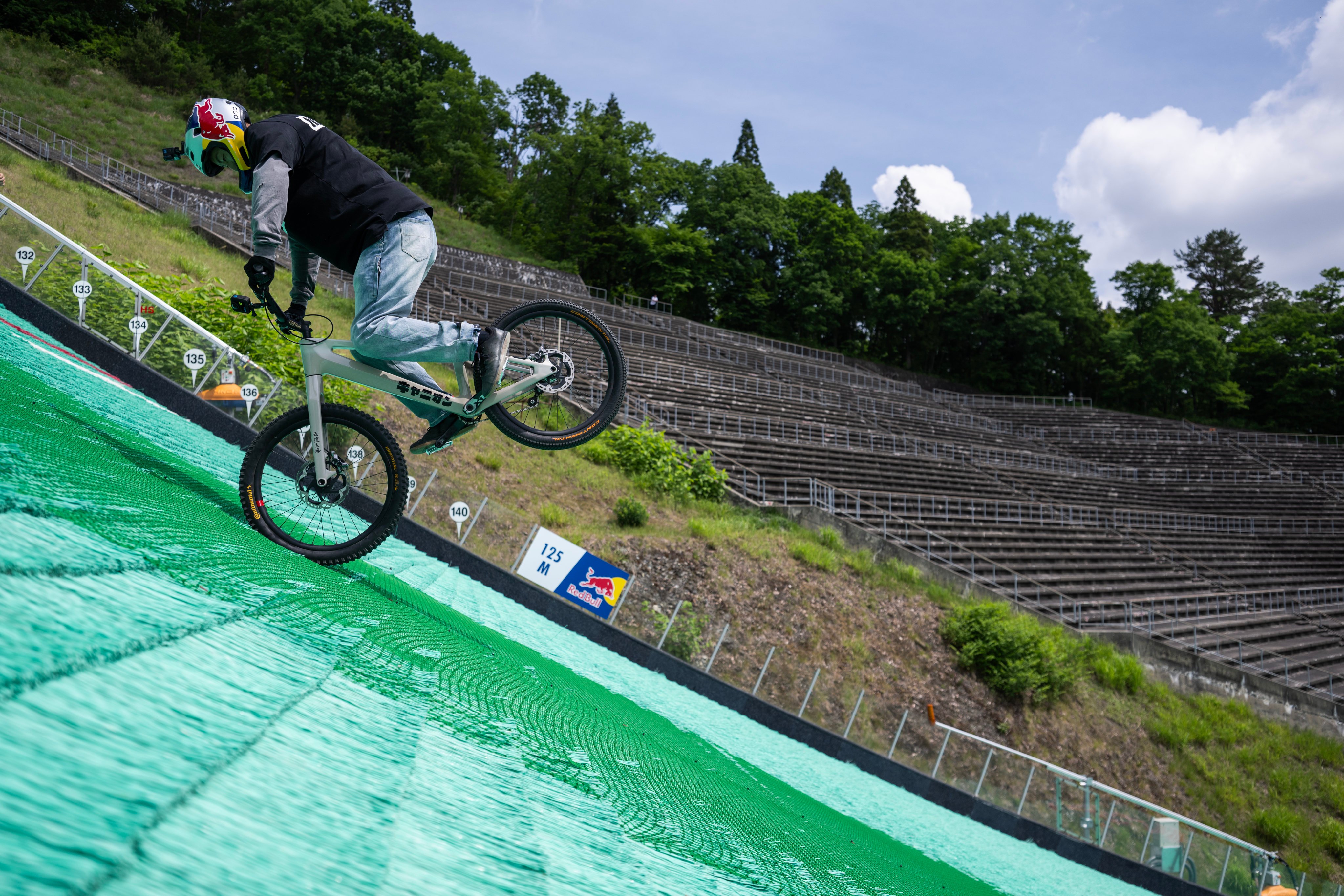 Japanese trials rider and Red Bull Athlete Tomomi Nishikubo set two new Guinness World Records for steepness and distance by completing a spectacular world-first descent down an Olympic ski jump in Hakuba performing a full fakie nose manual - riding backwards on one wheel for 136.6 metres on gradients up to 37.5 degrees. // Tomomi Nishikubo during the Red Bull Tomomi’s Steep Fakie project in Hakuba, Japan on May 27, 2026 // Jason Halayko / Red Bull Content Pool