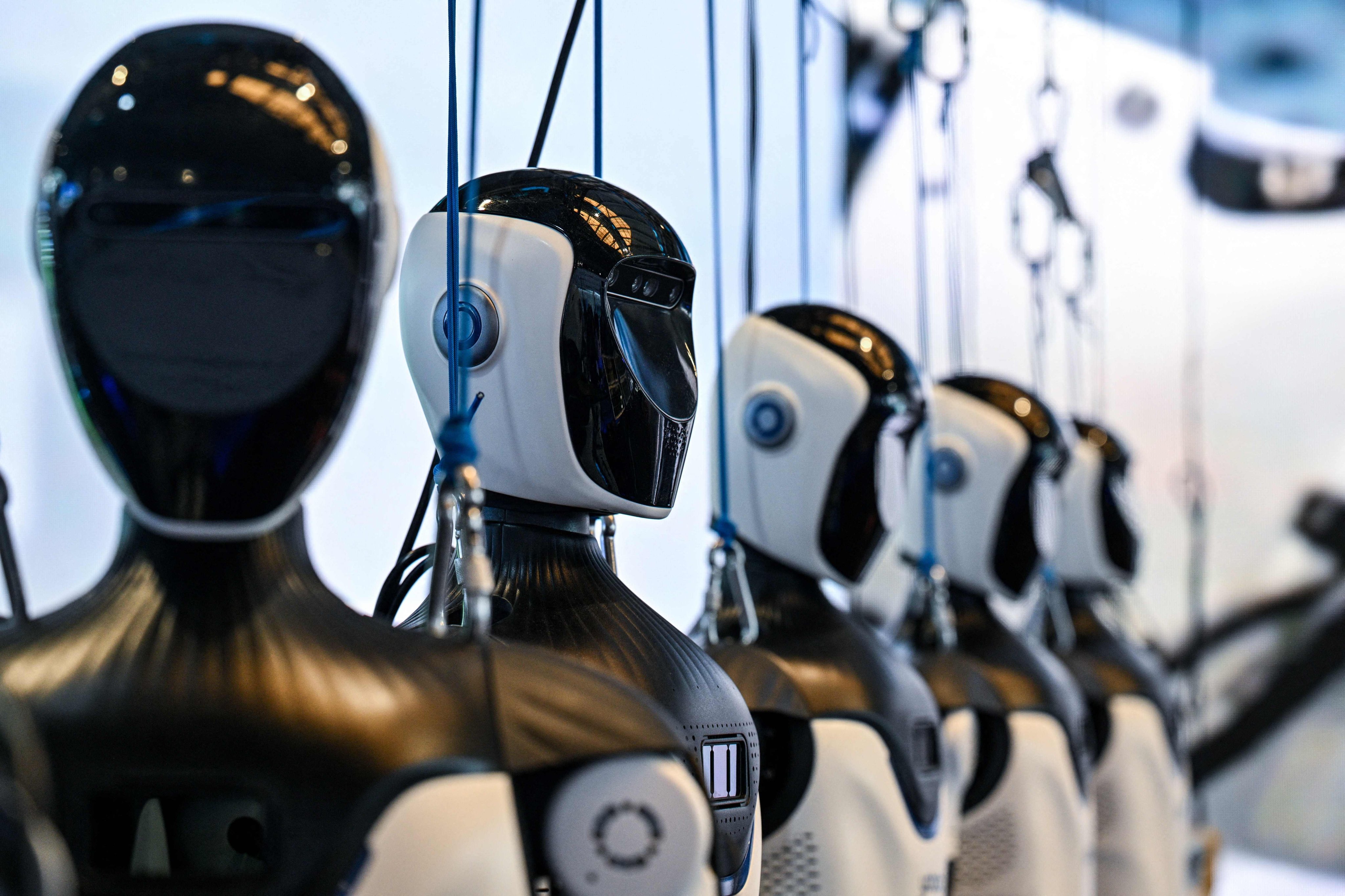 Humanoid robots developed by OpenMind Robotics at the World Artificial Intelligence Conference in Shanghai on Saturday. Photo: AFP