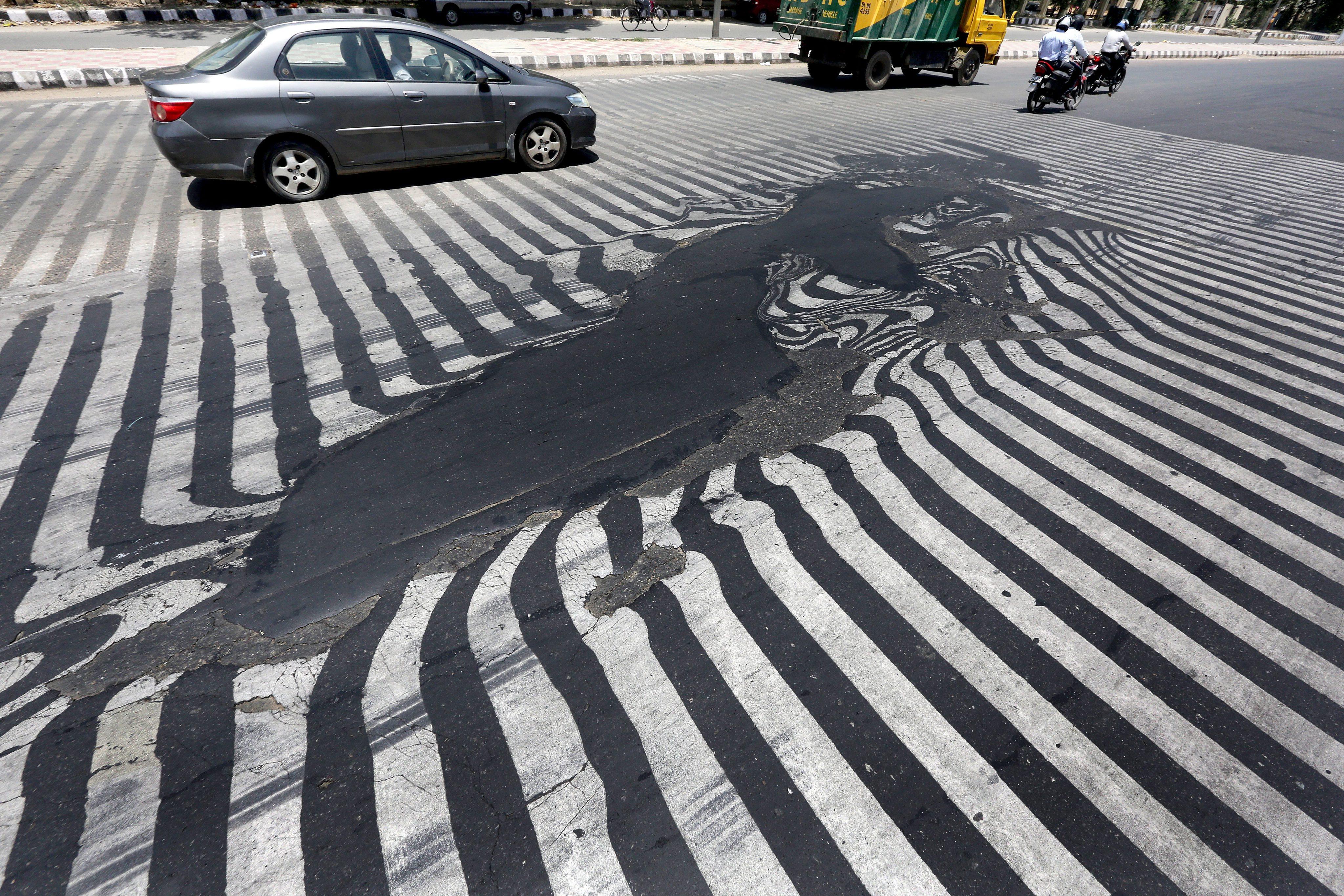 Melting asphalt, like this seen in India in the 2015 heatwave, is now increasingly common. Photo: EPA
