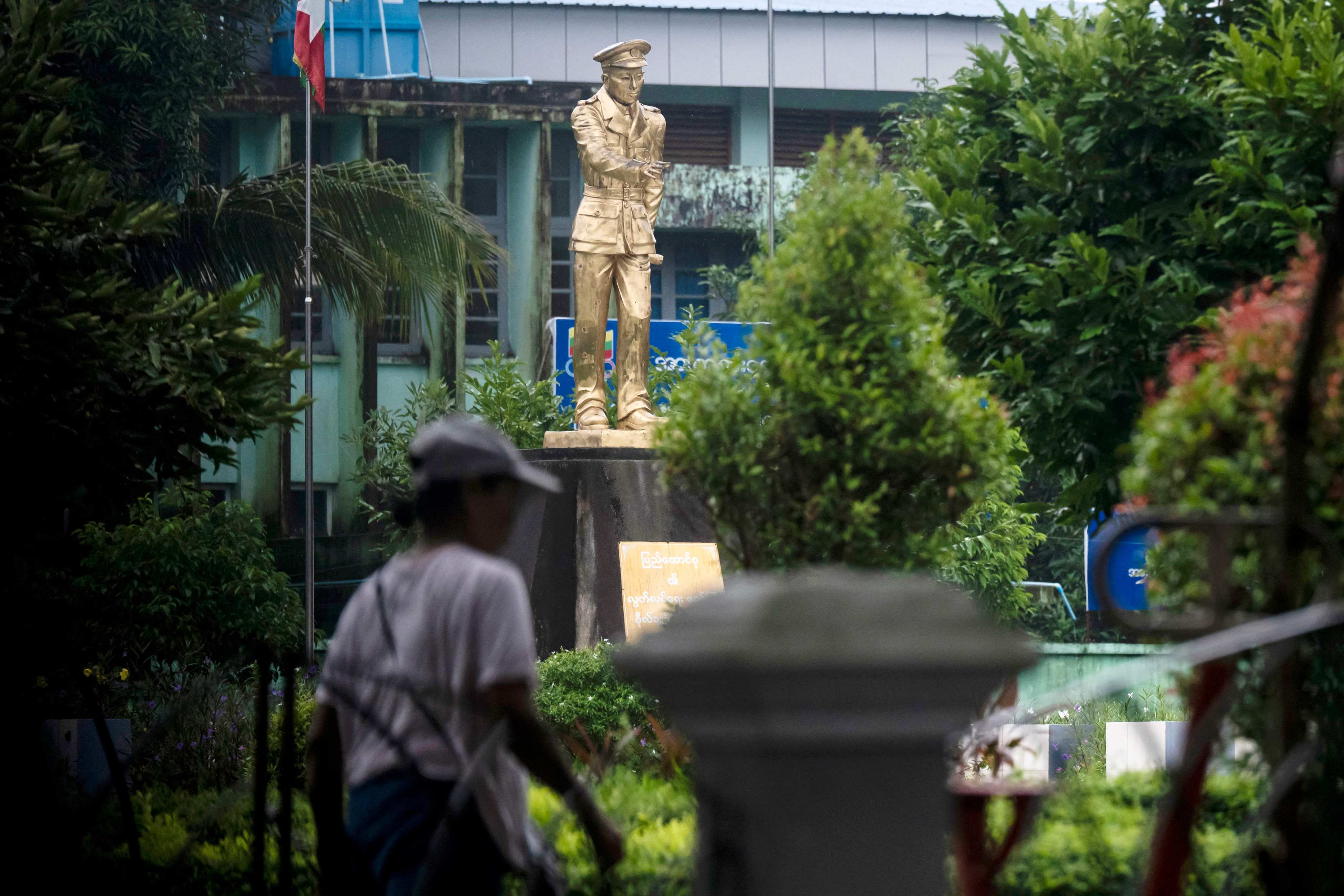 A woman walks past a statue of Myanmar’s independence hero Aung San at Thu Mingalar Park in Yangon on July 16. Photo: AFP