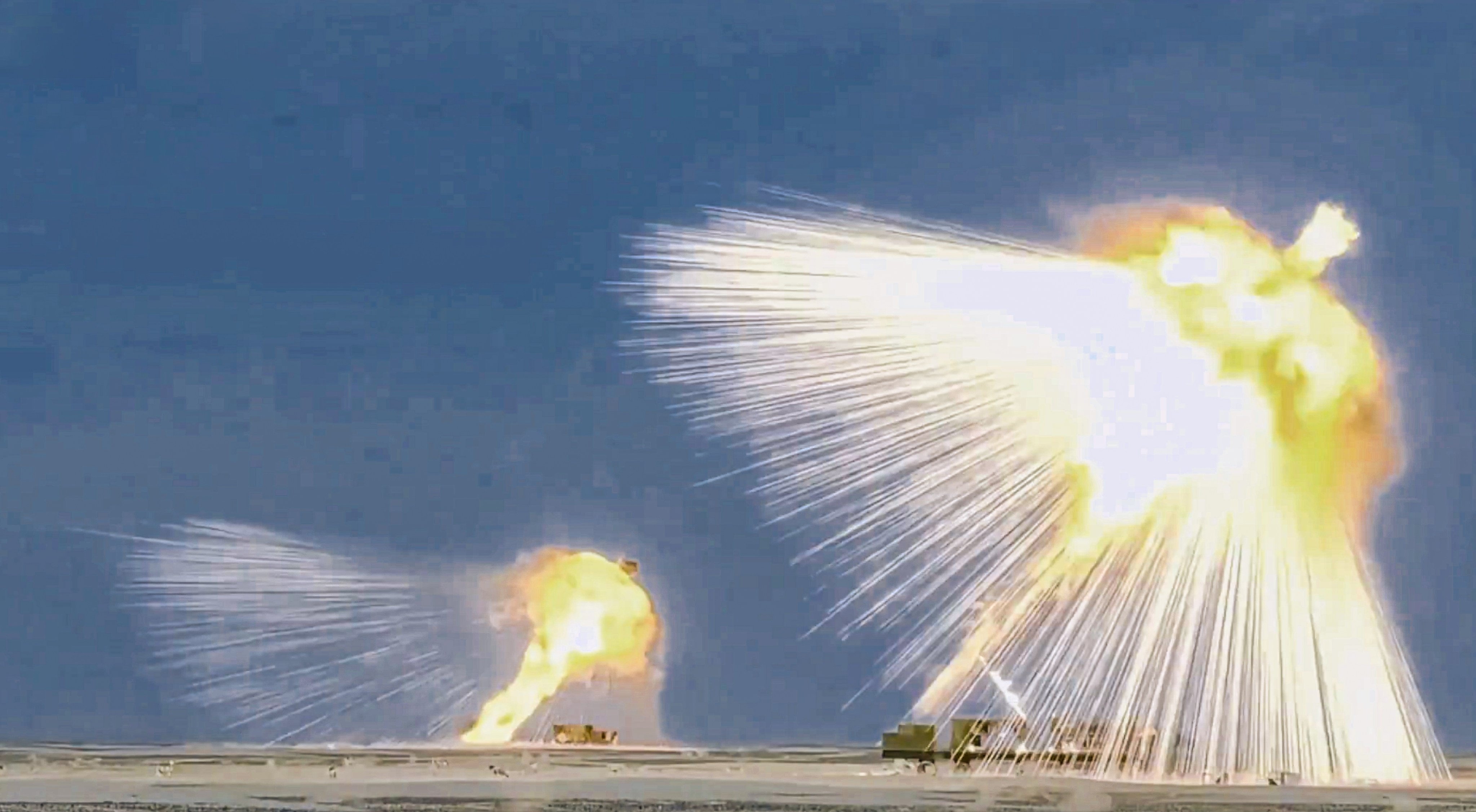 Footage from a PLA-affiliated social media channel on Sunday shows several PHL-191-launched rockets detonating above what appears to be a desert training range. Photo: Handout