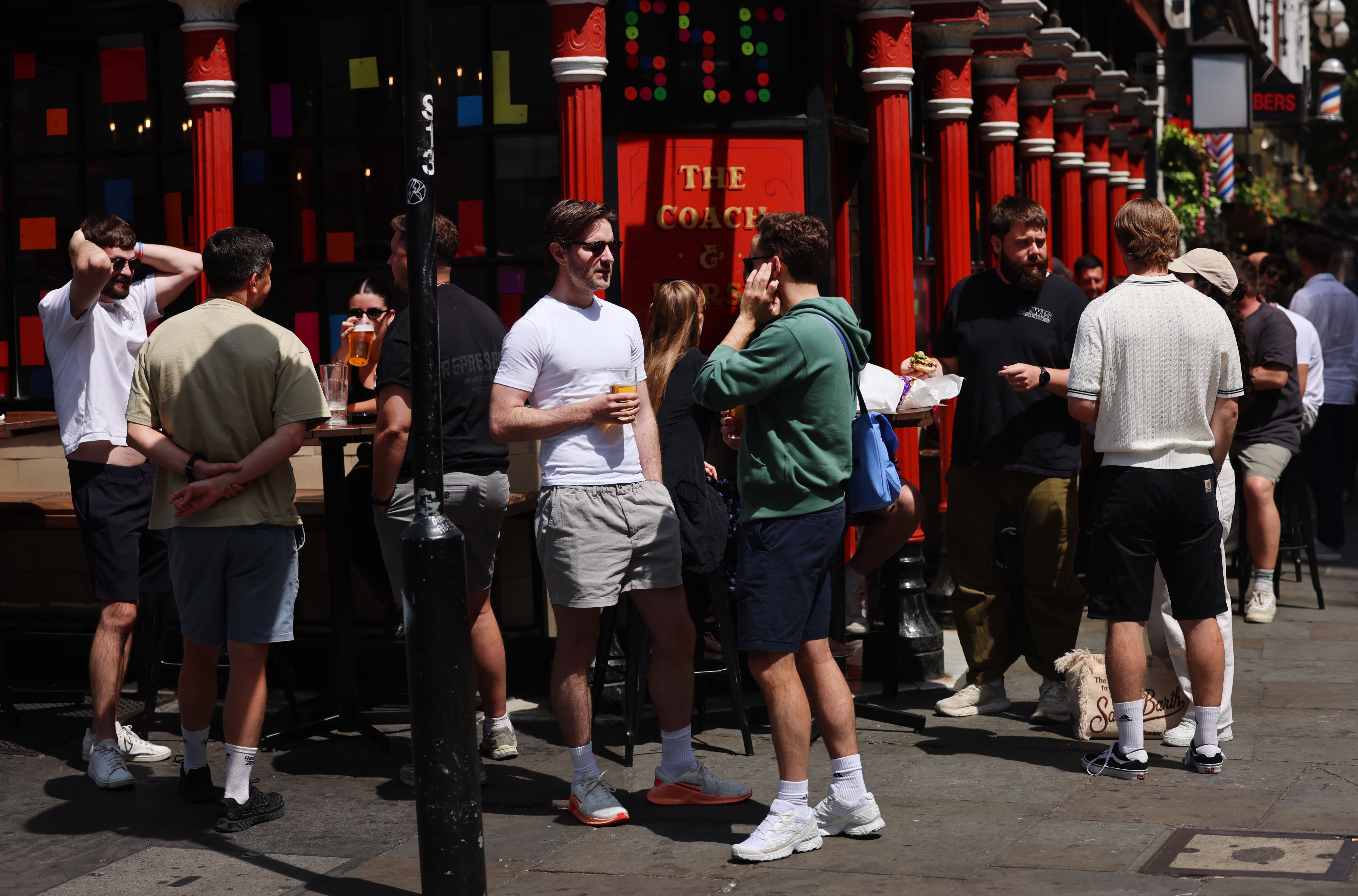 Customers drink outside a pub in London on July 3. Pubs, a quintessential cornerstone of British communities, are closing at the rate of around one a day. Photo: EPA