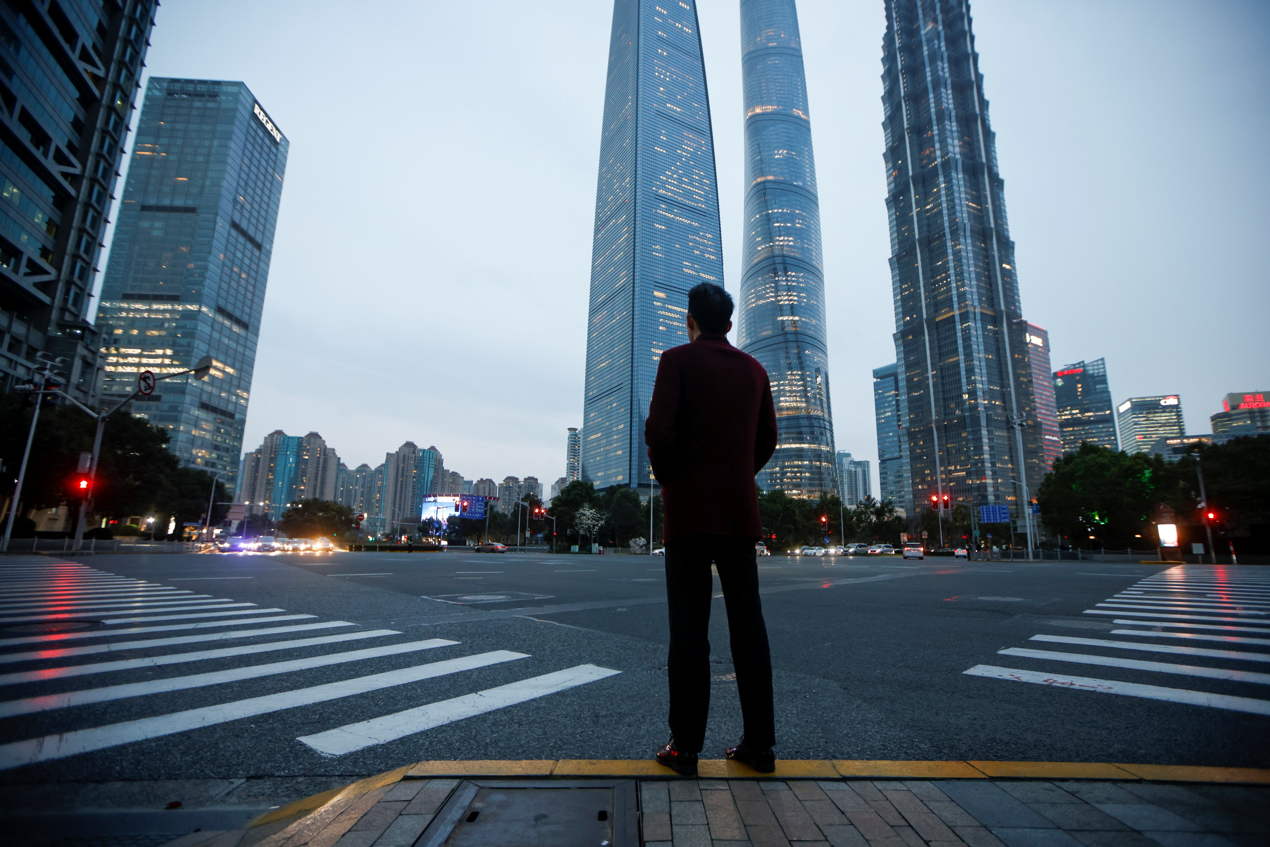 A man stands at a crossroads in Lujiazui financial district in Pudong, Shanghai, on March 5, 2021. Photo: Reuters