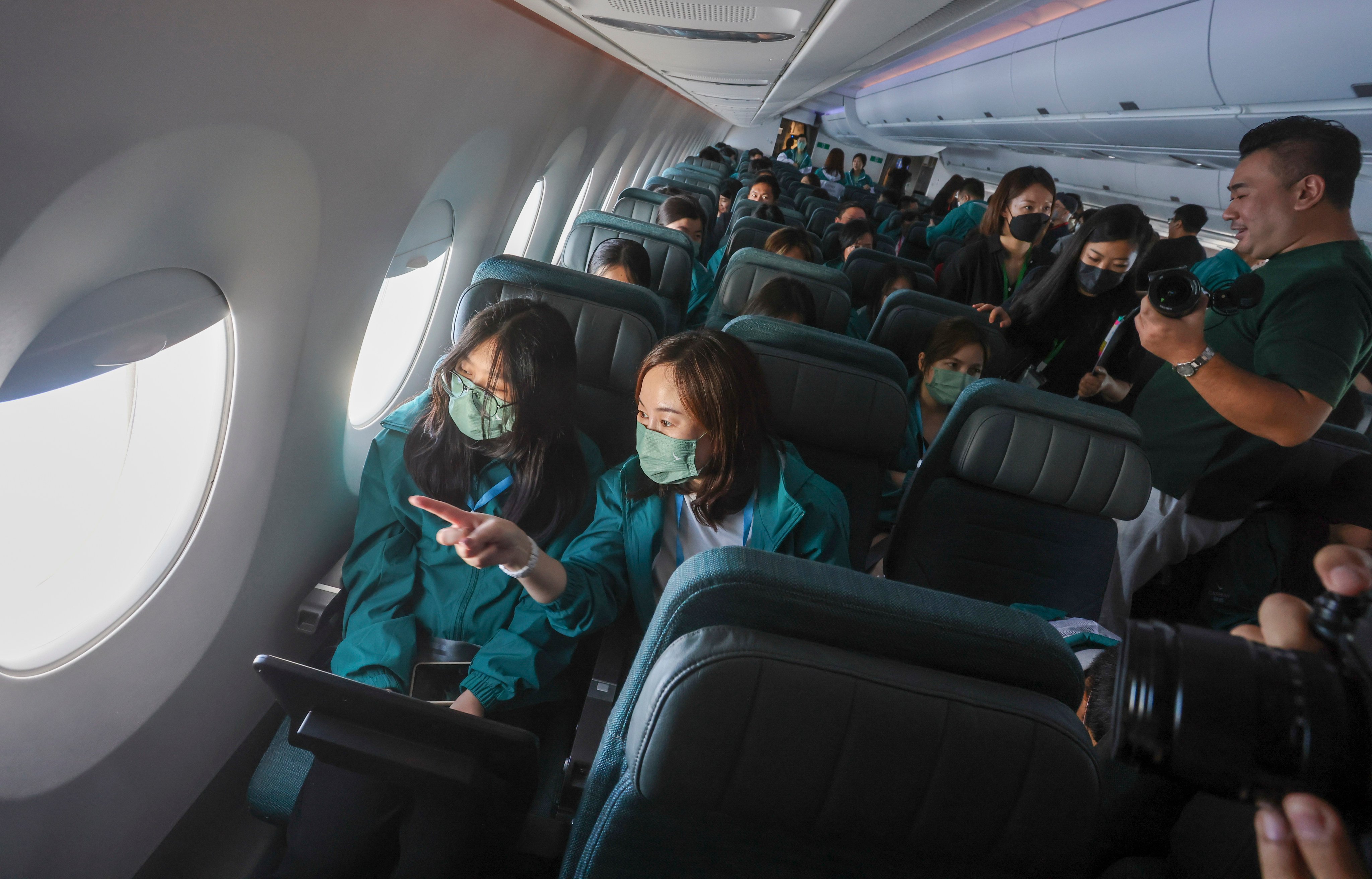 Dozens of students and their mentors took part in a Cathay Pacific community flight programme on May 21, 2023. Mentoring could begin simply, by matching adults with students or young employees and giving them a quiet place to talk. Photo: Jonathan Wong