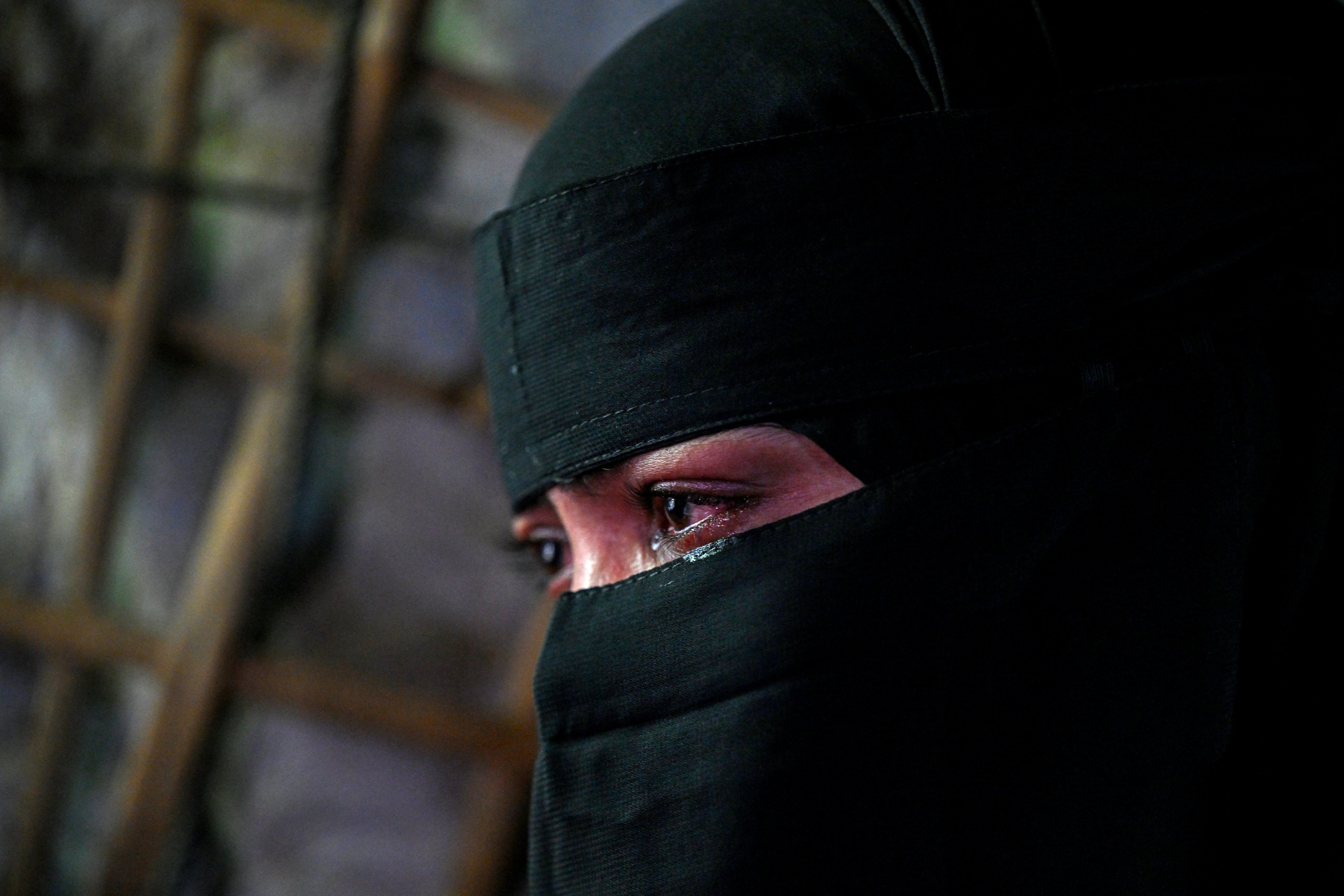 This photograph taken on June 20, 2026 shows Rohingya refugee Rahela Begum, who spent two days and a night adrift in the Andaman Sea clinging to a wooden plank before being rescued, crying during an interview with AFP at Kutupalong refugee camp in Bangladesh’s Cox’s Bazar. Thousands of Rohingya have tried in recent years to leave Cox’s Bazar, where more than a million refugees forced to flee war-torn Myanmar’s Rakhine state live in squalid conditions. (Photo by Munir UZ ZAMAN / AFP)