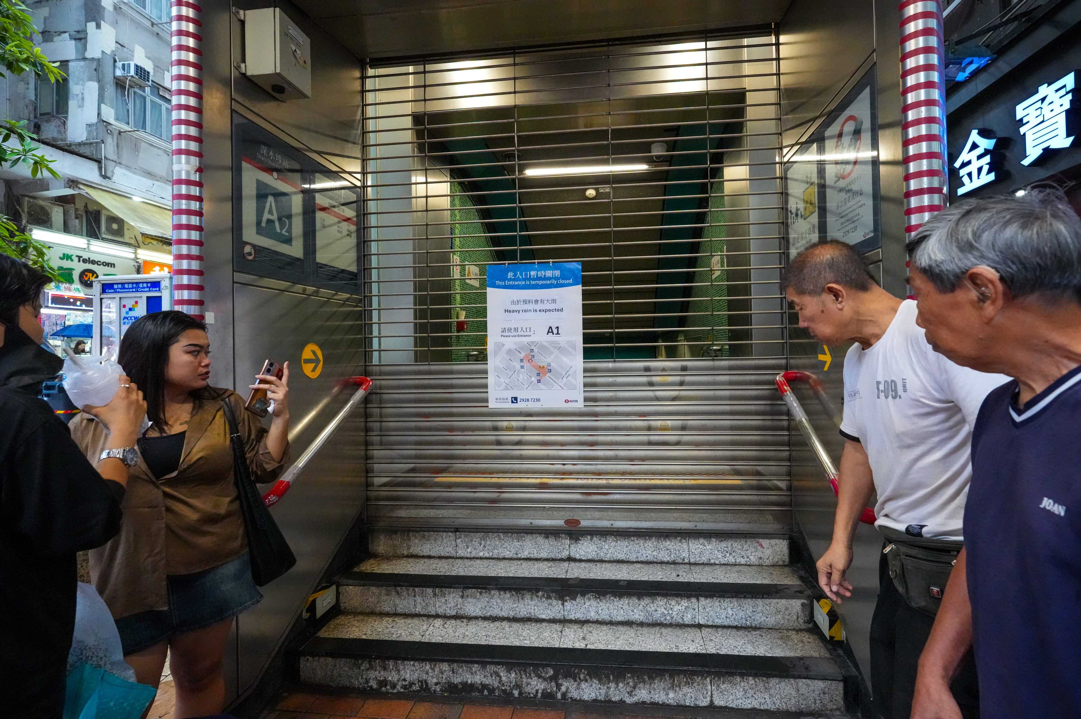 Flood barriers are up at an exit of the Sham Shui Po MTR Station after the Hong Kong Observatory issued a black rainstorm warning on June 18. Photo: Dickson Lee