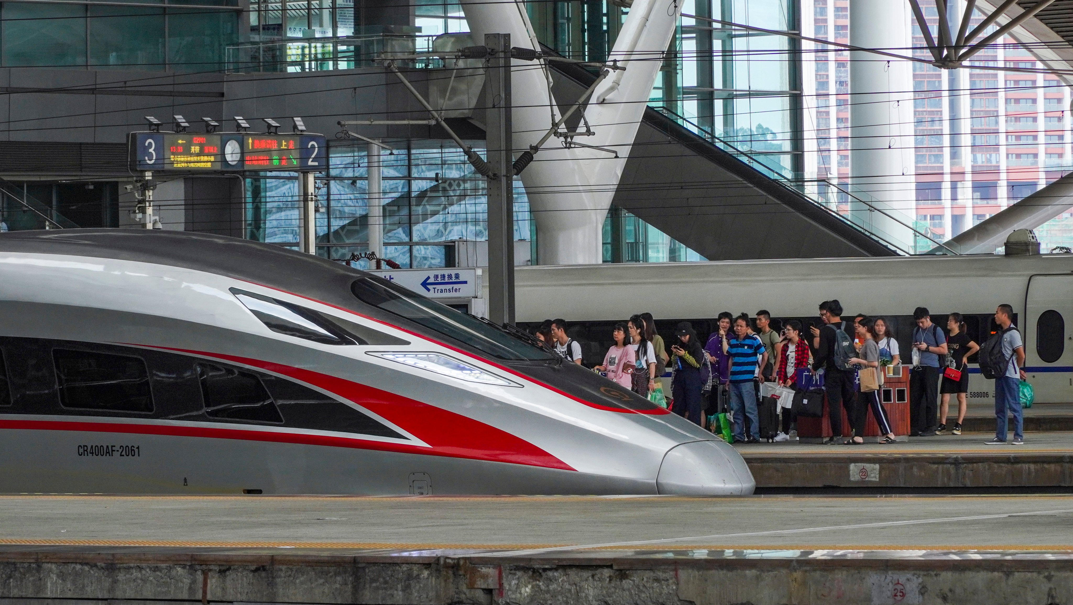 Travellers prepare to board a high-speed train at the Guangzhou South Railway Station. Photo: Roy Issa