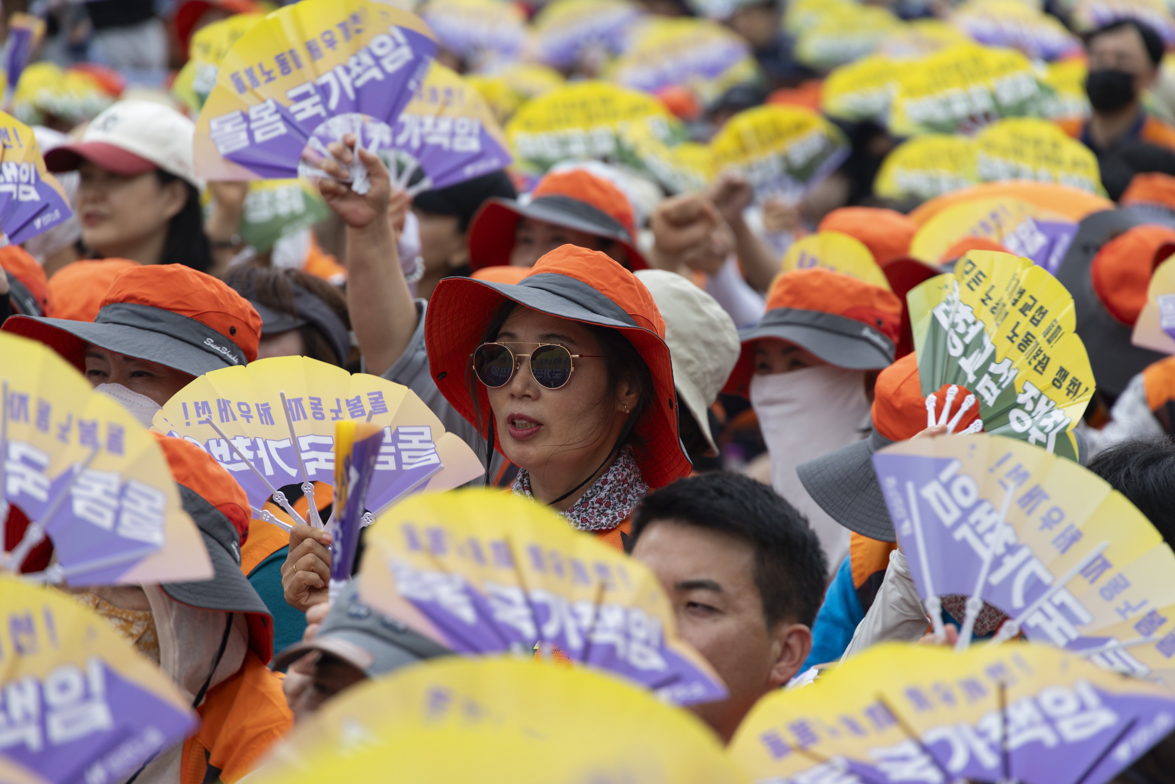 Members of the South Korean Confederation of Trade Unions hold signs reading “basic labour rights” during a rally in Seoul on July 16. Photo: EPA