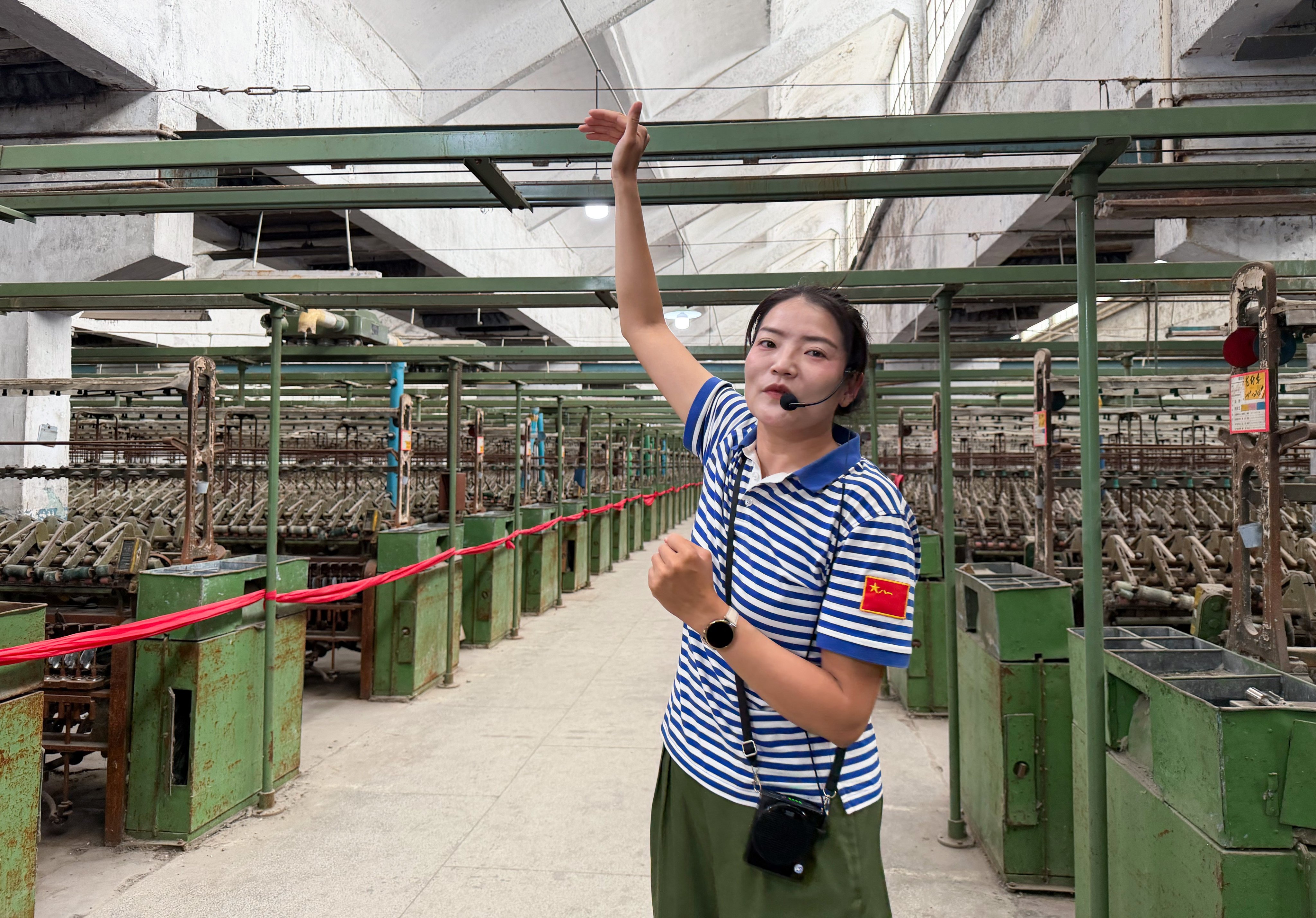 A Xinjiang guide explains the region’s history of cotton production during a factory tour. Photo: Edith Lin