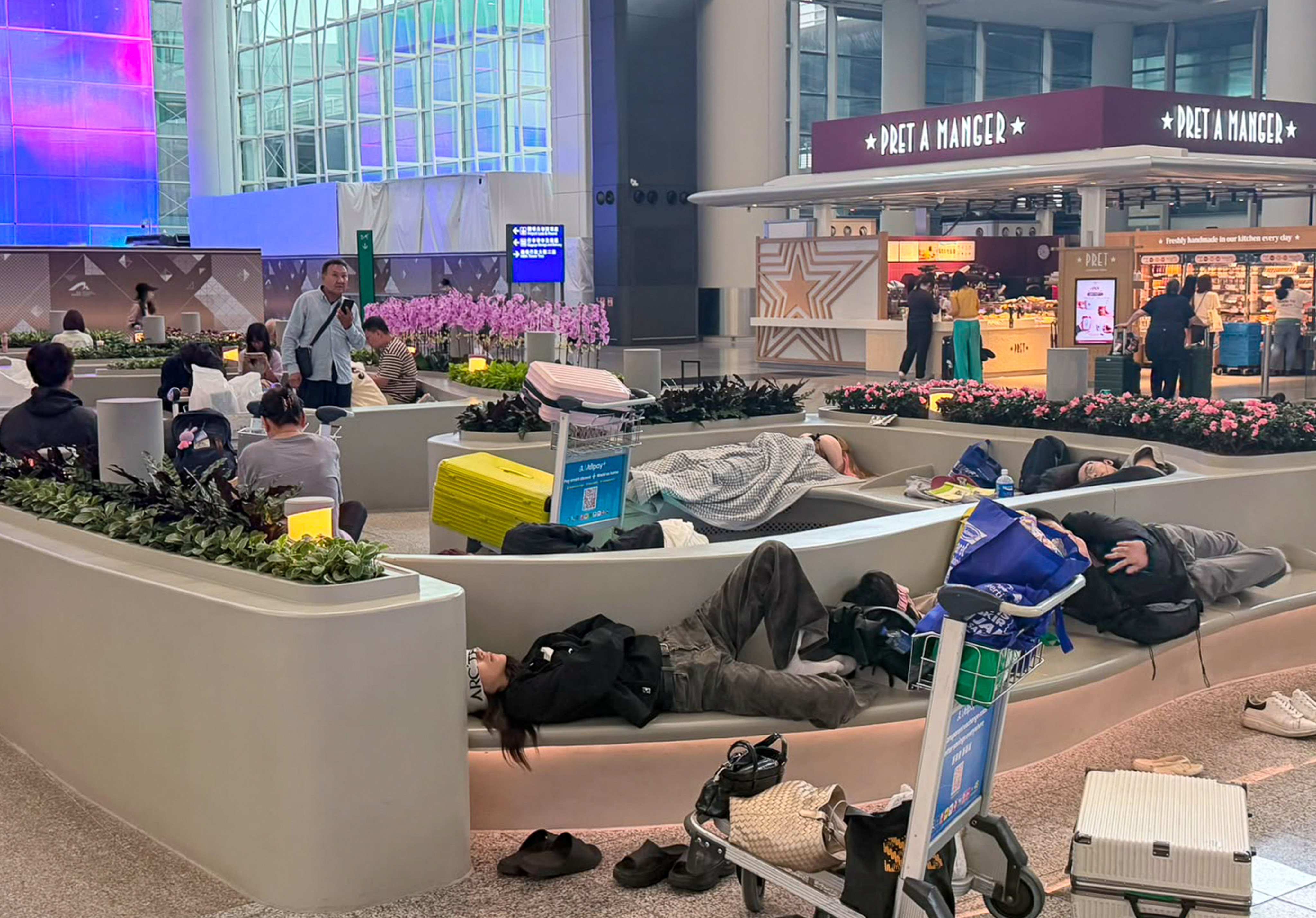 Passengers slept on benches at Hong Kong International Airport as Typhoon Noul battered the city overnight on Saturday. Photo: Eric Jiang