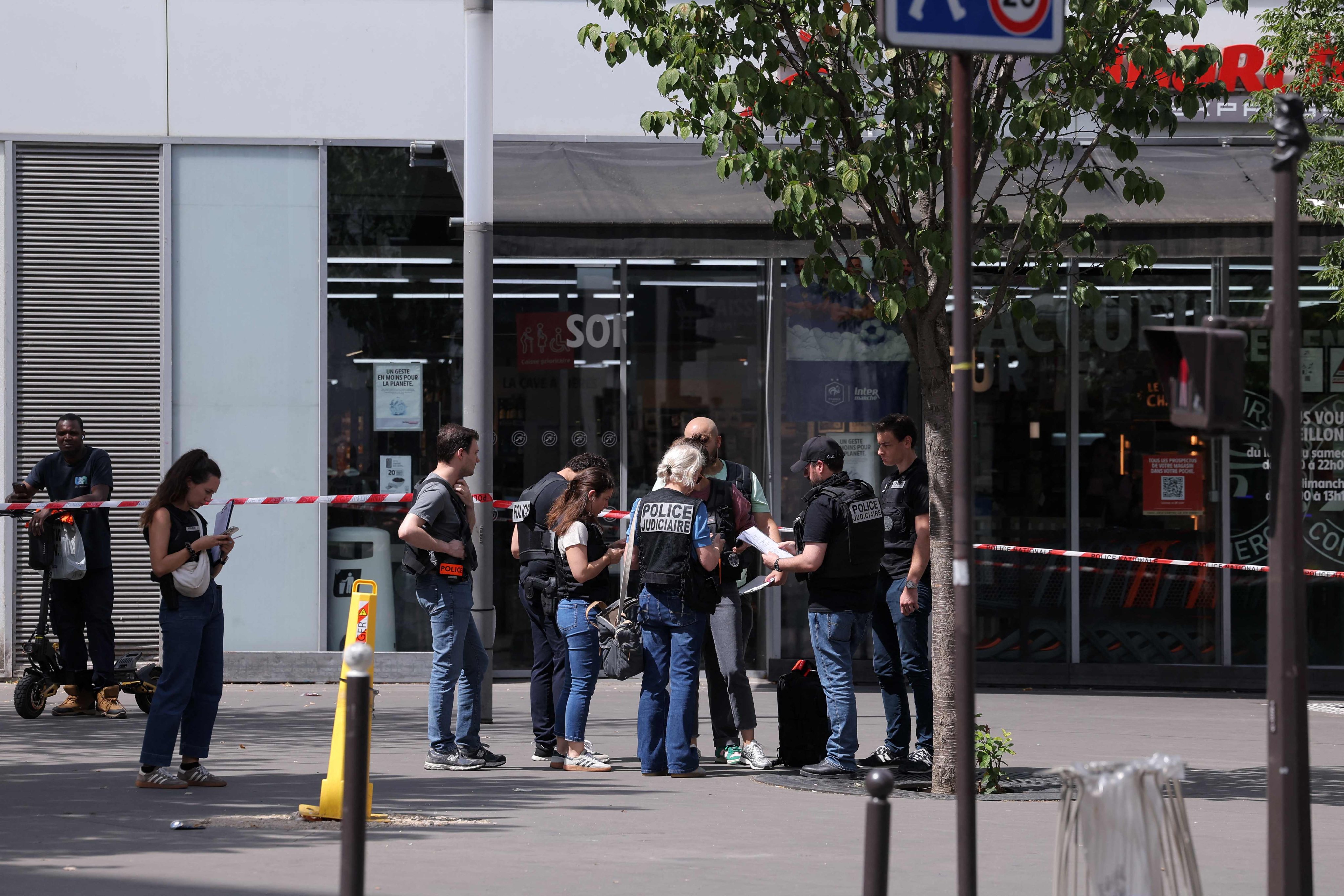 Police work in a cordoned off area after a knife-wielding man wounded three people in Paris on Monday. Photo: AFP