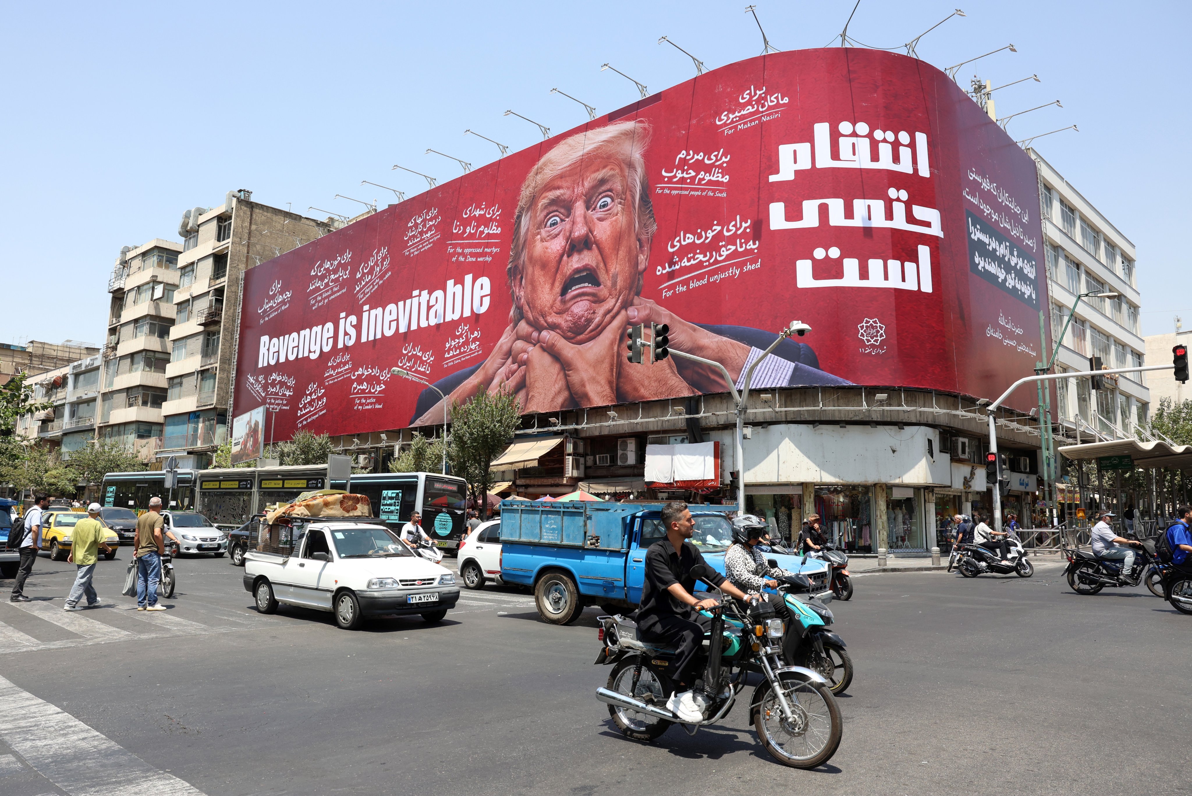 People drive past an anti-US and Trump billboard in Tehran on Monday.Trump said on Friday he had not decided whether to return to an all-out operation. Photo: EPA
